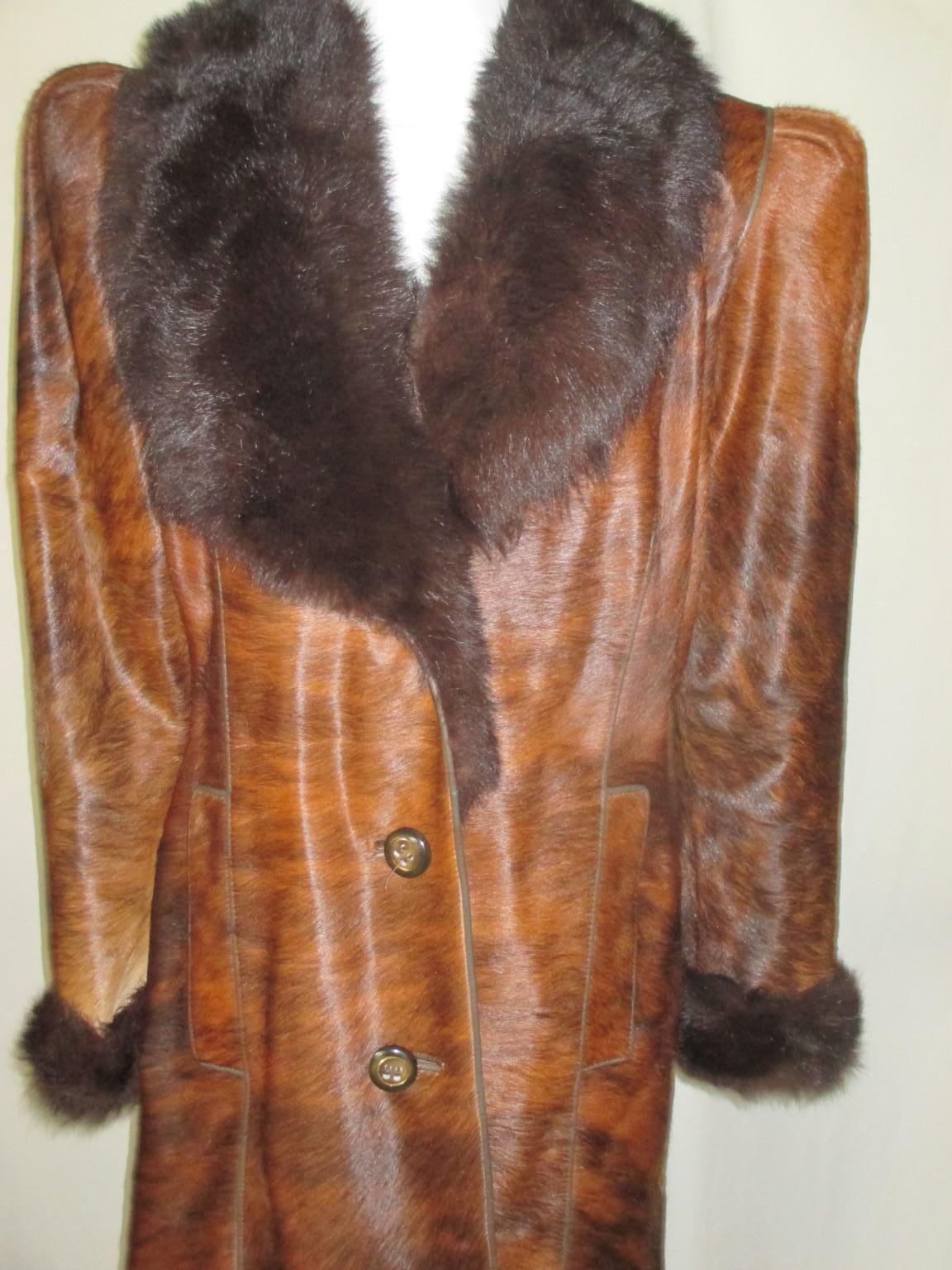 Amazing vintage hand made coat from pony skin/cowhide with lamb fur collar, cuffs and statement shoulders.

We offer more luxurious fur items, view our storefront.

Details:
With 2 pockets, 3 buttons, fully lined, leather trimmed.
Designer: Bauza