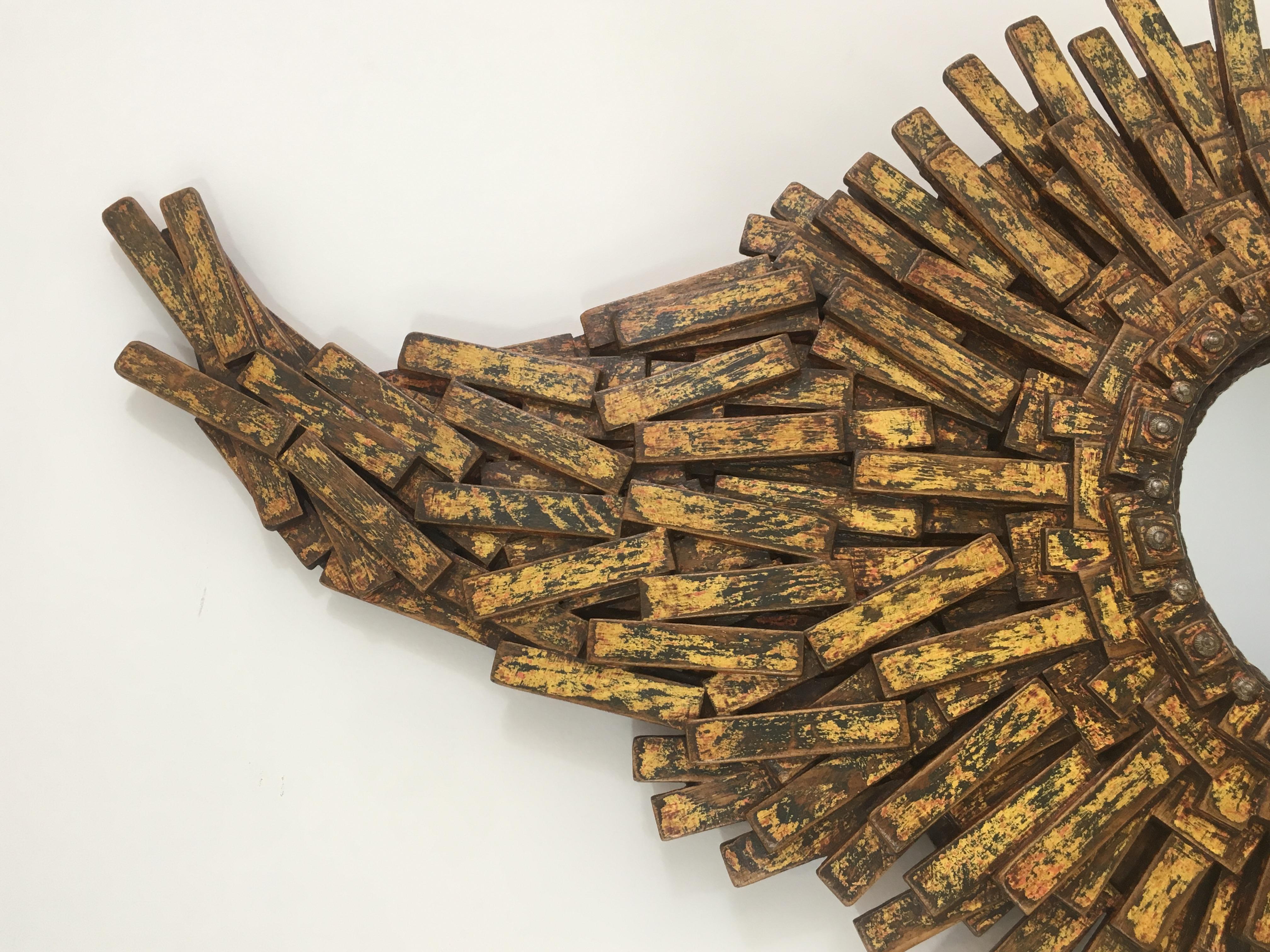 This unique amazing Brutalist mirror is made of painted wood, rope & old iron nails. This is a fantastic work of art made of hundreds of oak pieces representing a large sunburst mirror with a flame on top of it. The quality of this creation is