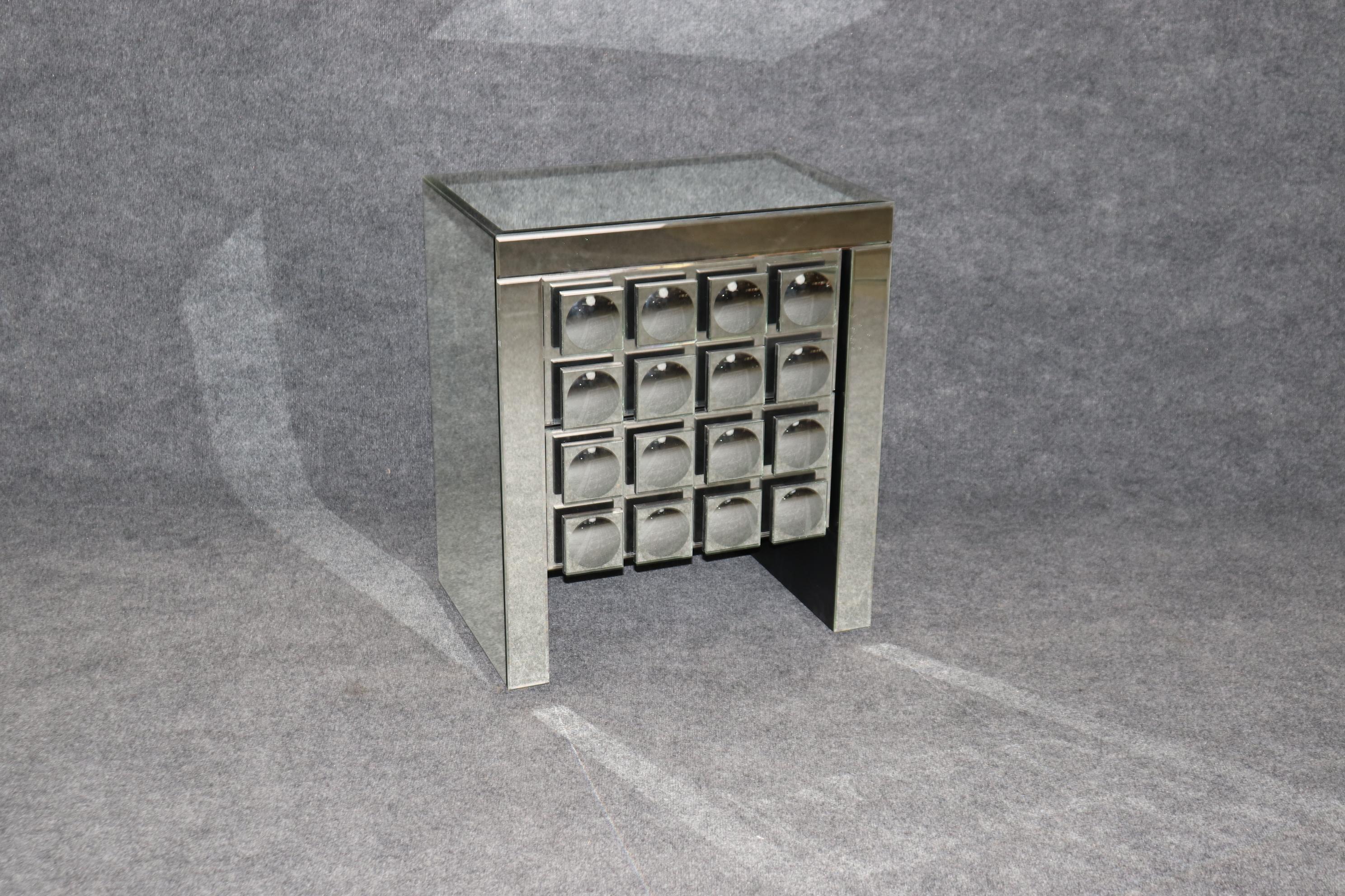 This is a very unique mirrored Brutalist or post-modern style mirrored chest. The piece is designed in the manner of the French designer De Coene Frères who mostly used wood to make his works, but this is done in mirrored glass. This is in good