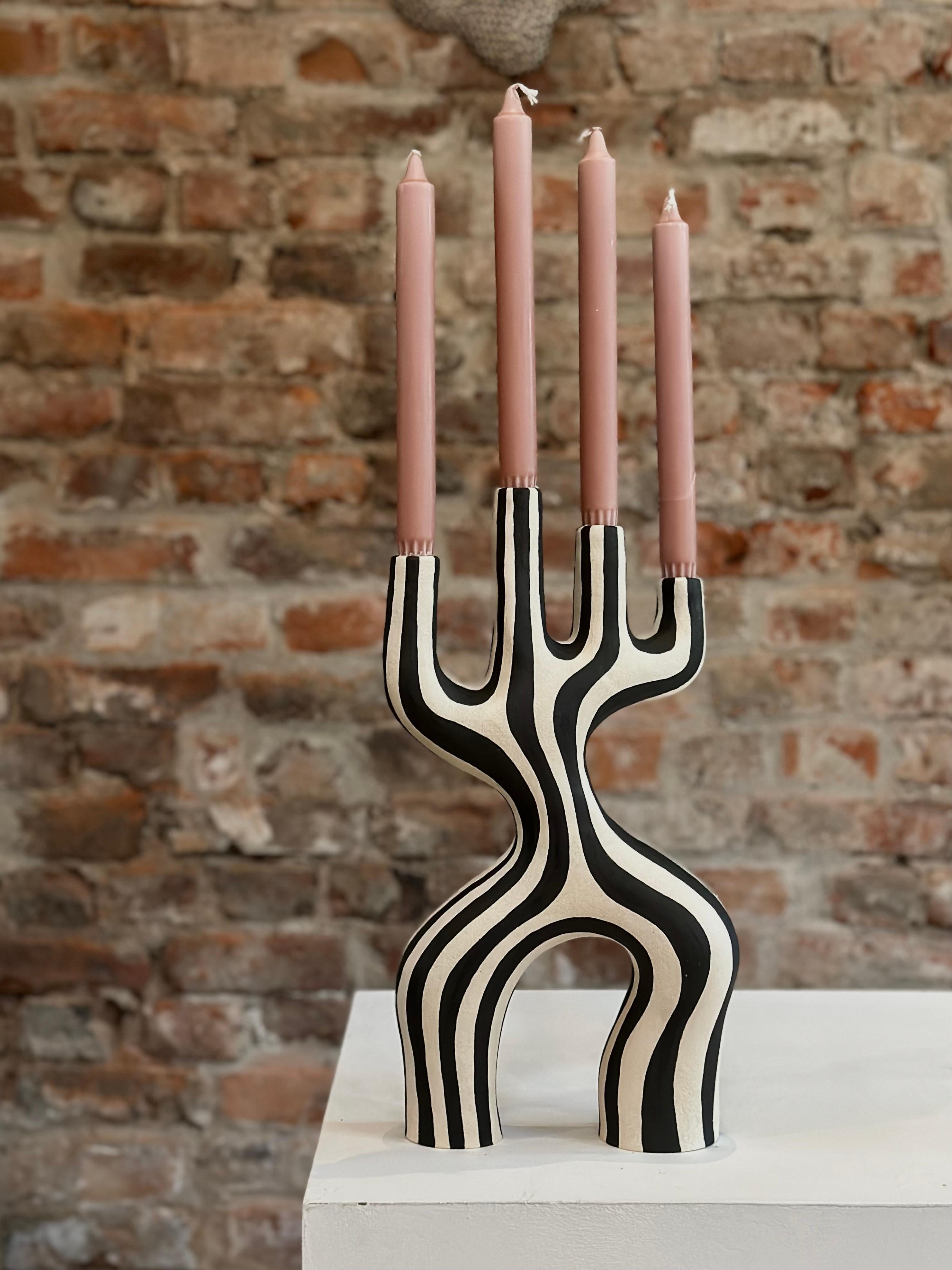 This unique candle holder is handcrafted by the Norwegian artist Johanne Birkeland, who works under the artist name Jossolini. 

The candelabras are all built and decorated by hand, so no piece is like another. The size and shape will still be