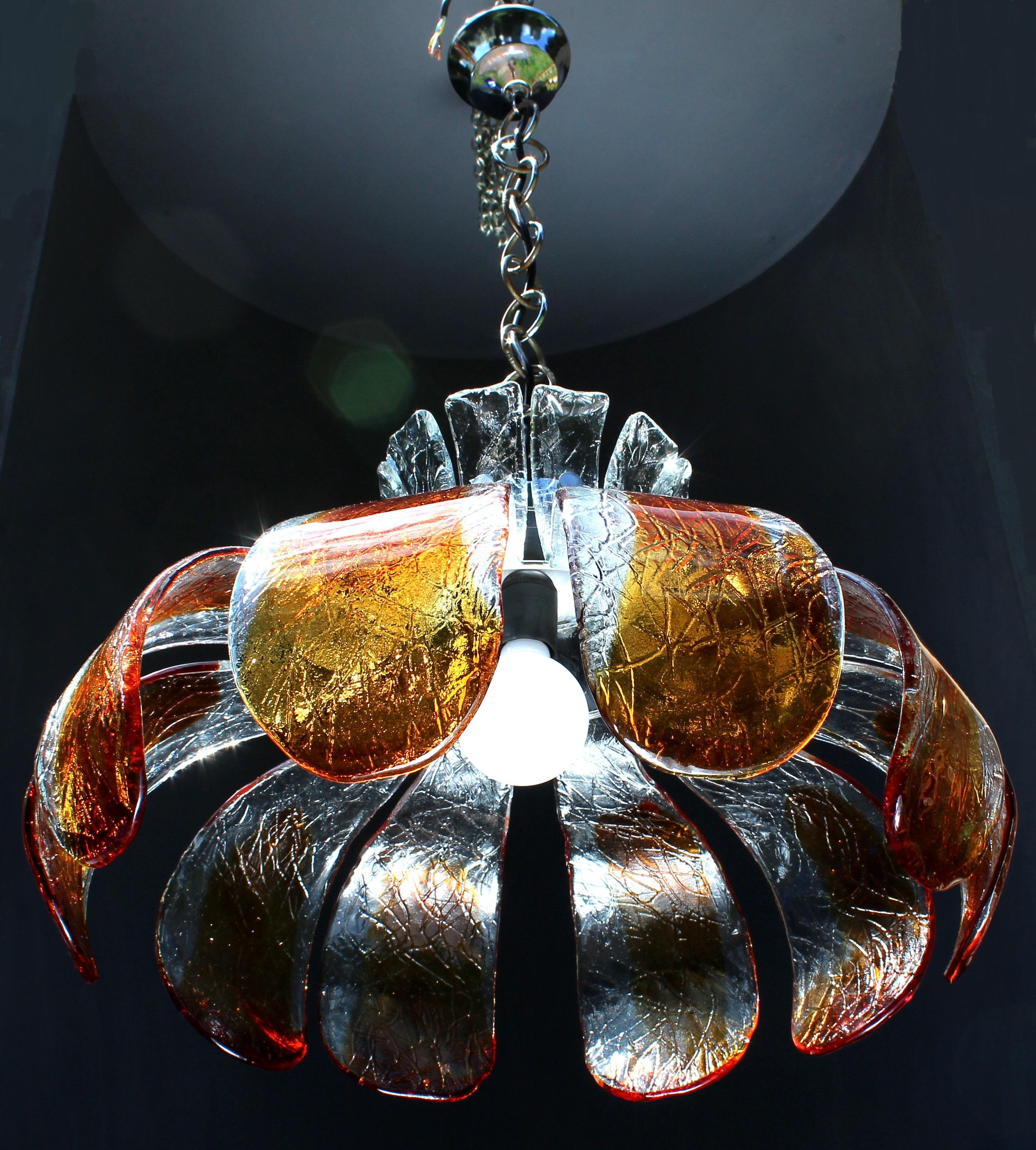 Unique flower chandelier by Carlo Nason in clear & dark amber, Italy, 1970s

10 + 1 handmade moulded and fused glass leafs in clear & dark amber art glass

This small, but heavy chandelier is in original good vintage condition, carefully