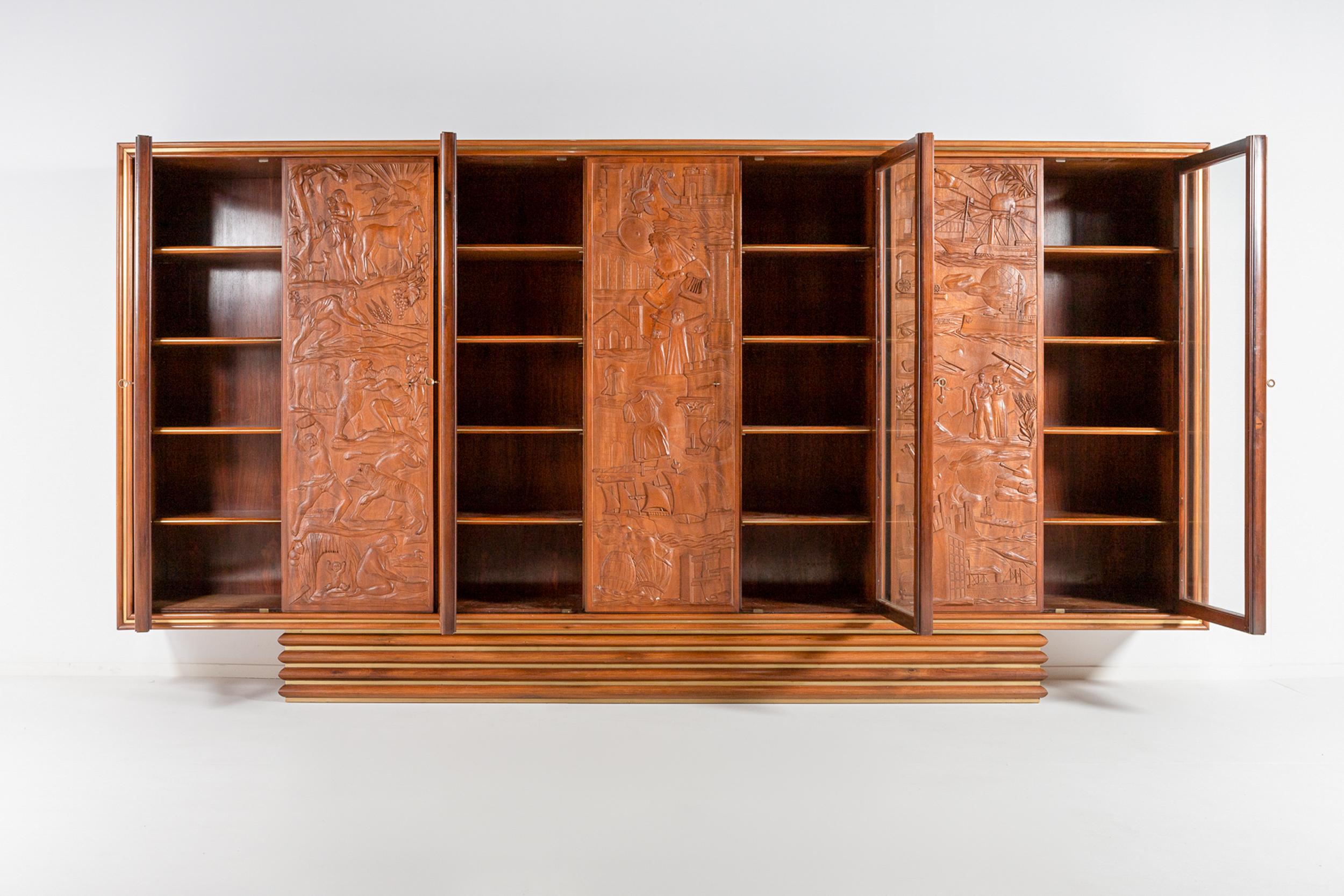 A superb massive Italian walnut and rosewood display cabinet. 
This sideboard features carved doors in walnut and glass doors with delicate rosewood frames.
The interior is completely finished in wonderful bookmarked rosewood veneer.
All shelves are