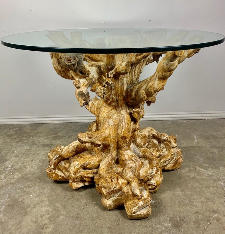 Unique carved wood table base that depicts a tree trunk with cut branches. The fine details show the small roots, branches and details that you would see in a tree trunk. The piece was originally painted but much of the paint is gone exposing the