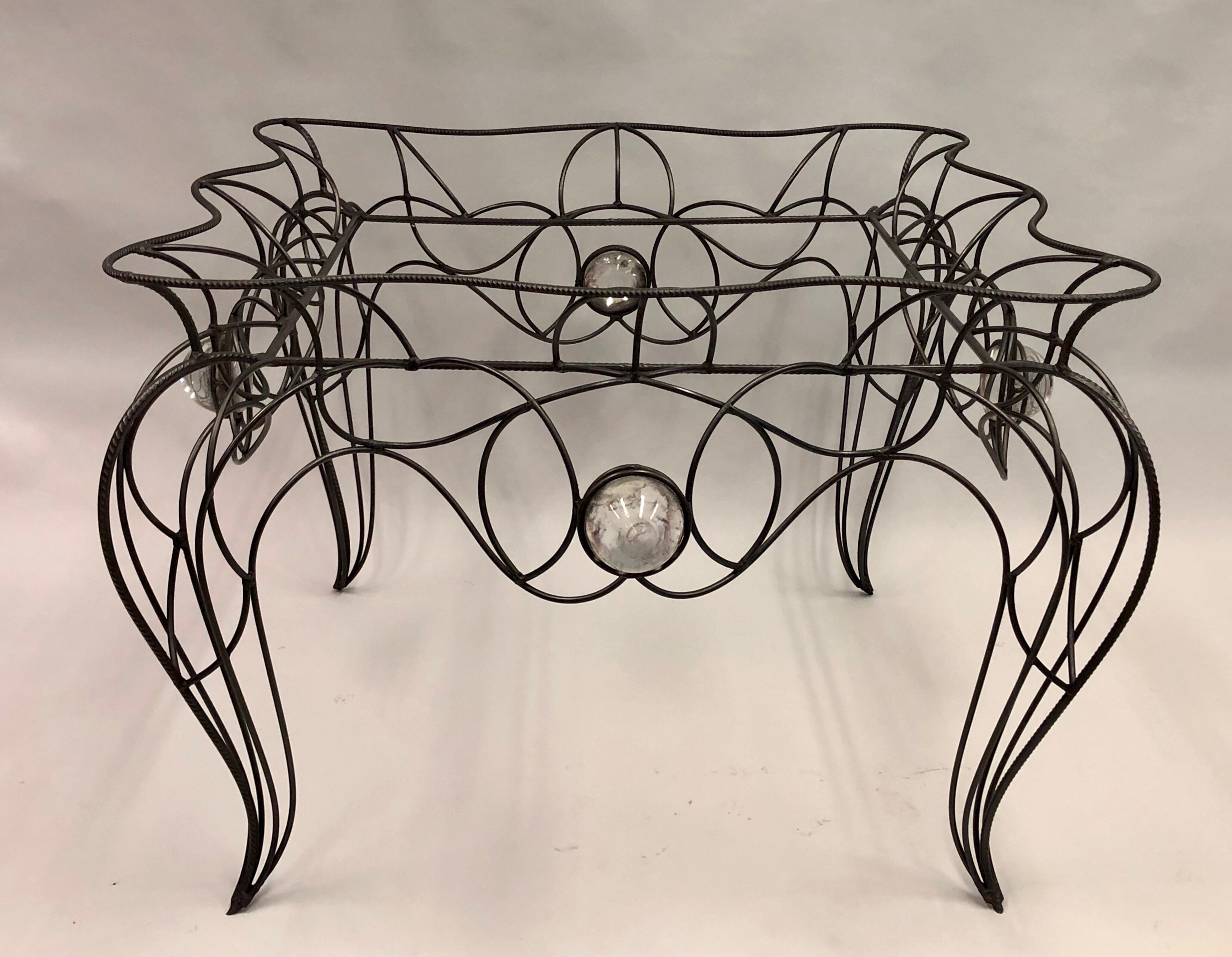 A unique, early, handmade piece by Andre Dubreuil.

Handwrought iron frame with four inset hand blown glass balls supporting a serpentine hand painted wood and gesso top.

Literature: 
Andre Dubreuil, Poete du Fer, Editions Norma, Paris, 2006,