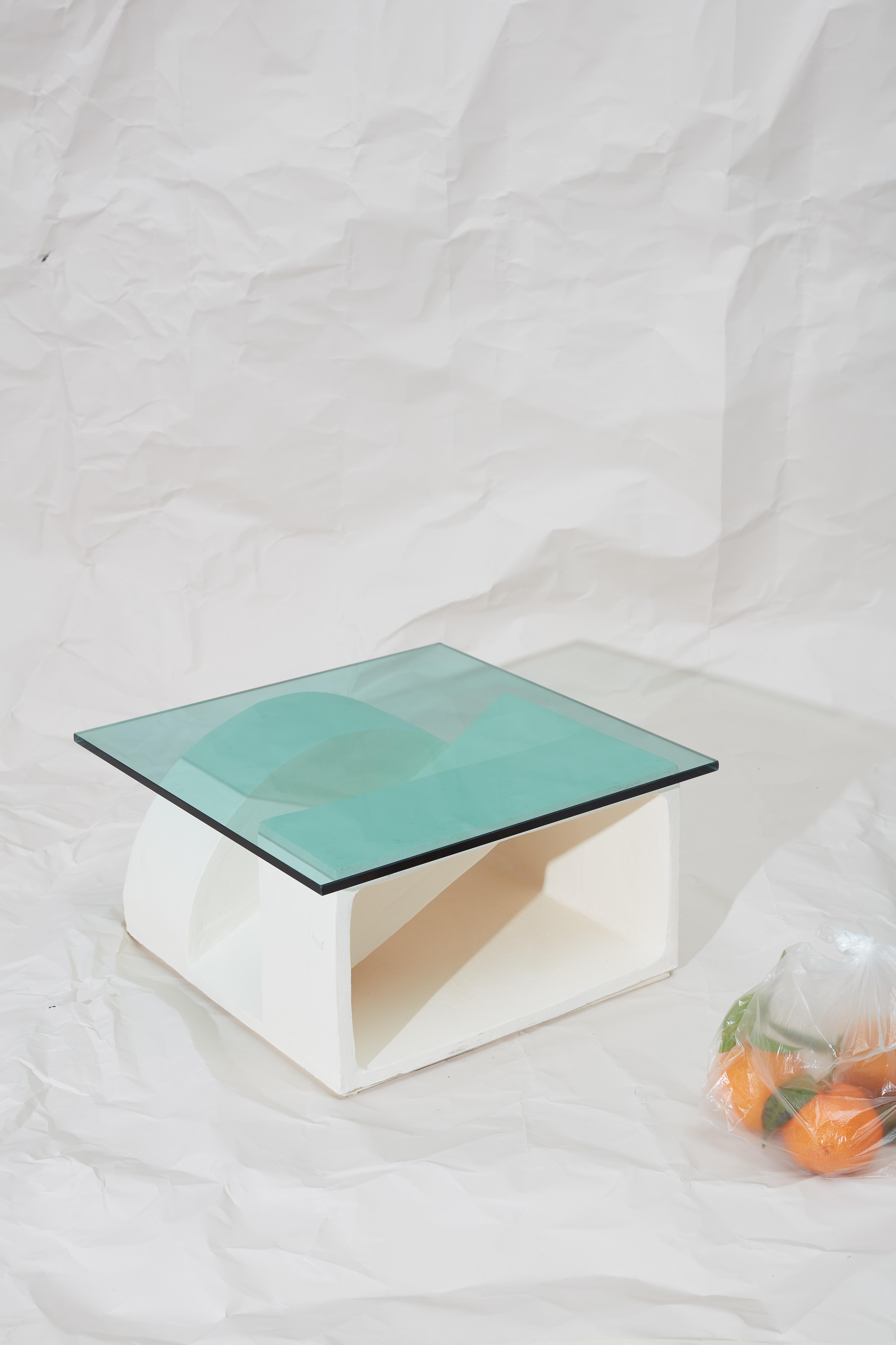 Unique ceramic side table by Theodora Alfredsdottir
Unique 
Materials: white. Stoneware and green glass
Dimensions: 40 x 40 x 20 cm
 Glass 44 x 44 x 0.6 cm

A collection of ceramic side tables that explore the possibility of using a single