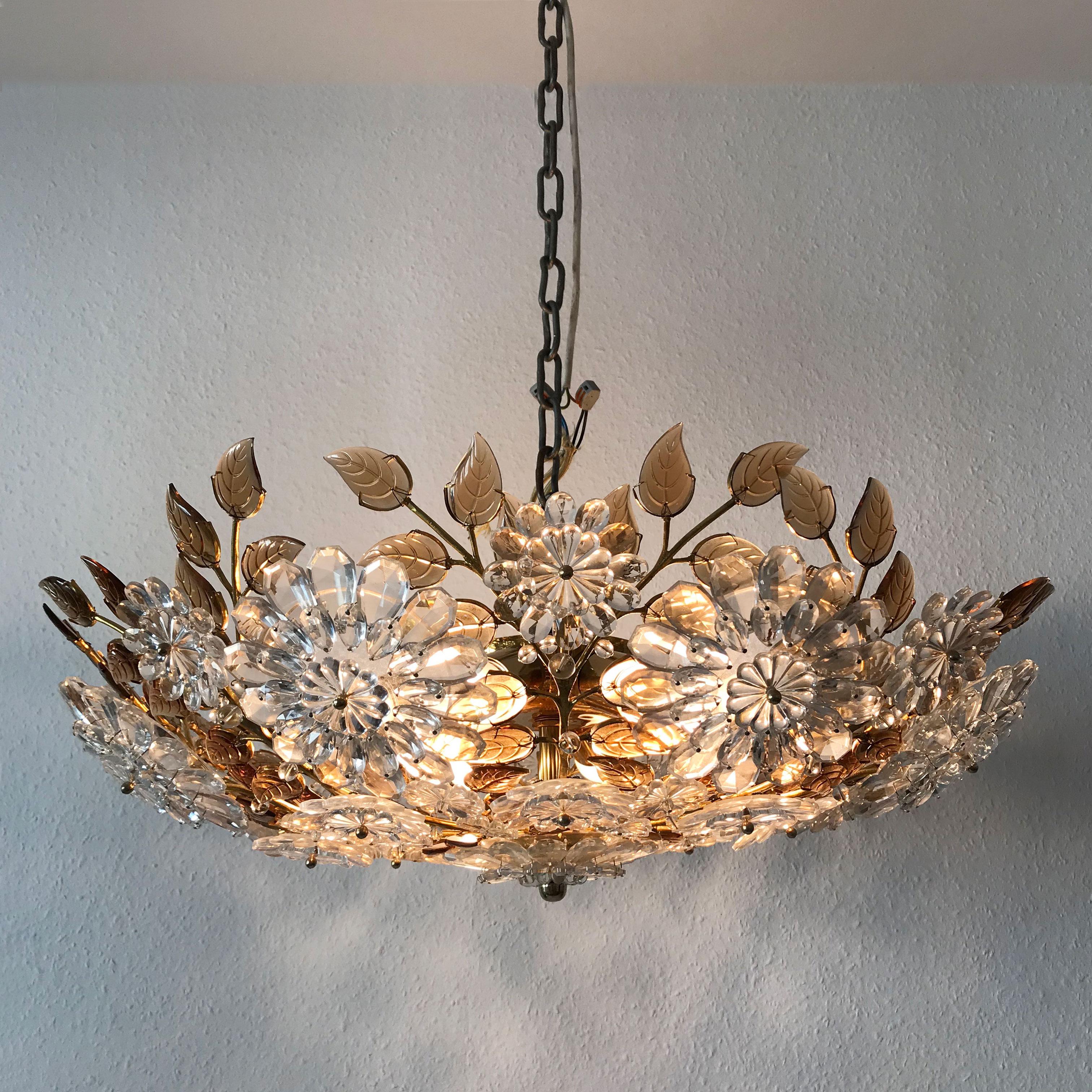 Gorgeous, exceptional Mid-Century Modern flower crystal chandelier or flush mount fixture in the Style of Oswald Haerdt for Lobmeyr, 1960s. A product of uncompromising craftsmanship and quality.

The lamp is executed in gilt brass and hundreds of