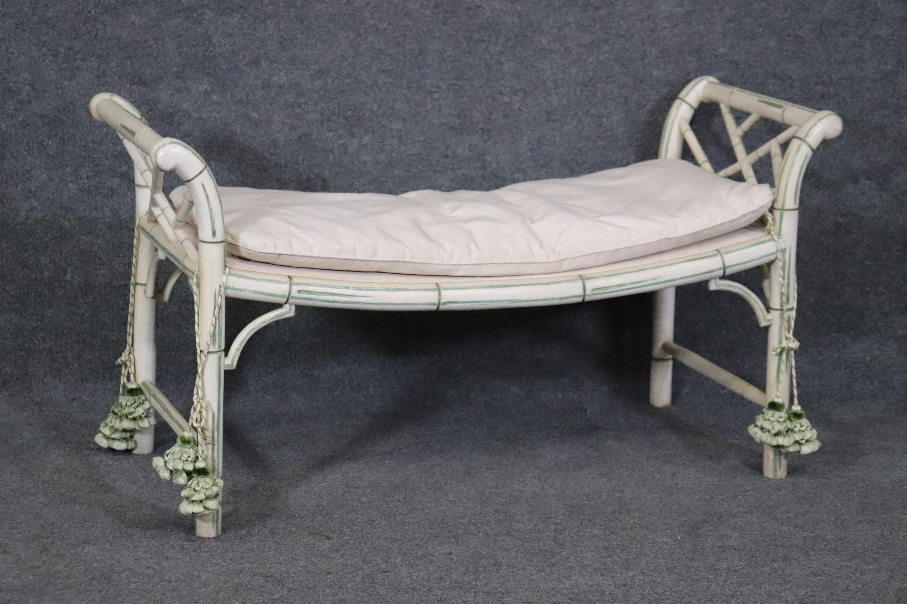 This is a pretty and unique Chinese Chippendale style faux bamboo bench. The bench is in good condition and has minor signs of age and wear but nothing significant. The upholstery is in good vintage condition but may have some signs of age and