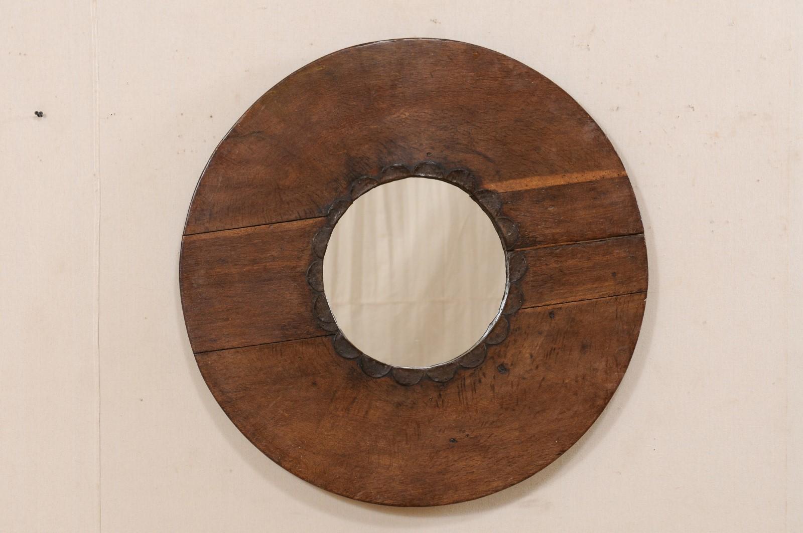 This custom mirror has been creatively up-cycled with an old N. African wooden cooking utensil as the surround, with new mirrored glass in it's center. This mirror features a circular-shaped mirror, within a round-shaped wooden frame from N. Africa,