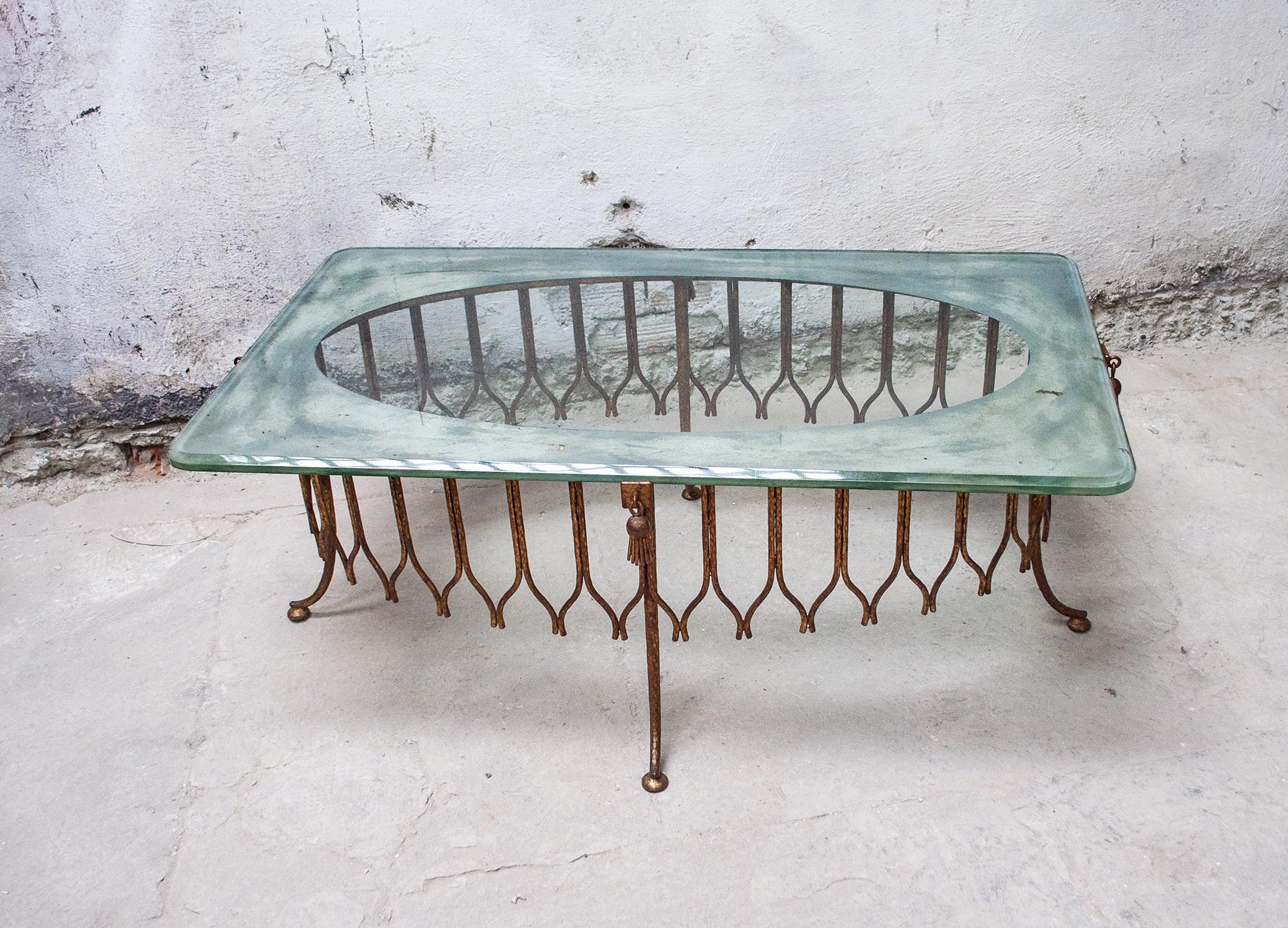 Coffee table with structure in gilded iron, glass top and silvered glass.
Italian production,
1940s.