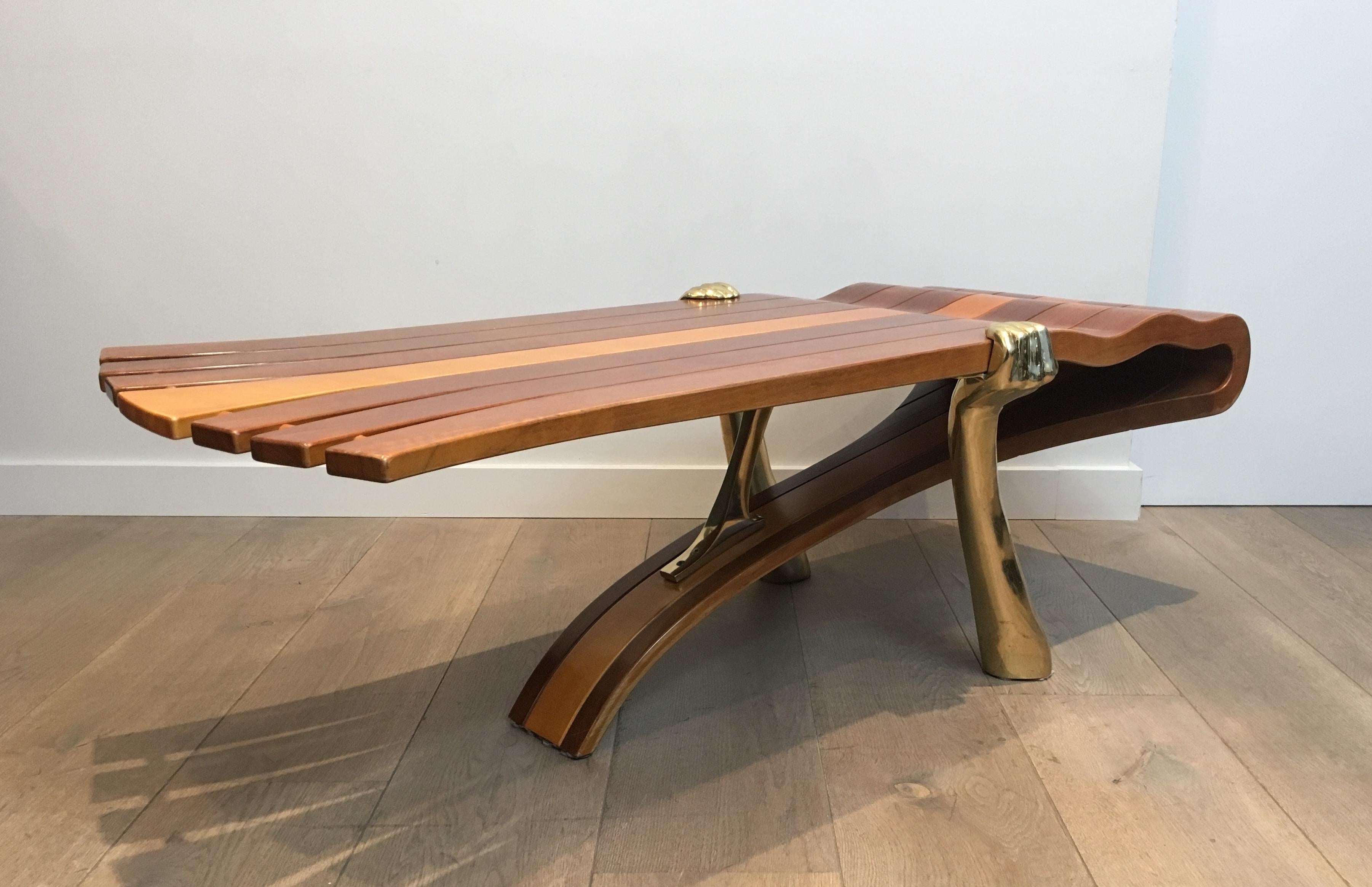 Mid-Century Modern Unique Coffee Table Made of a Thick Freeform Wood Top Supported by Brass Arms For Sale