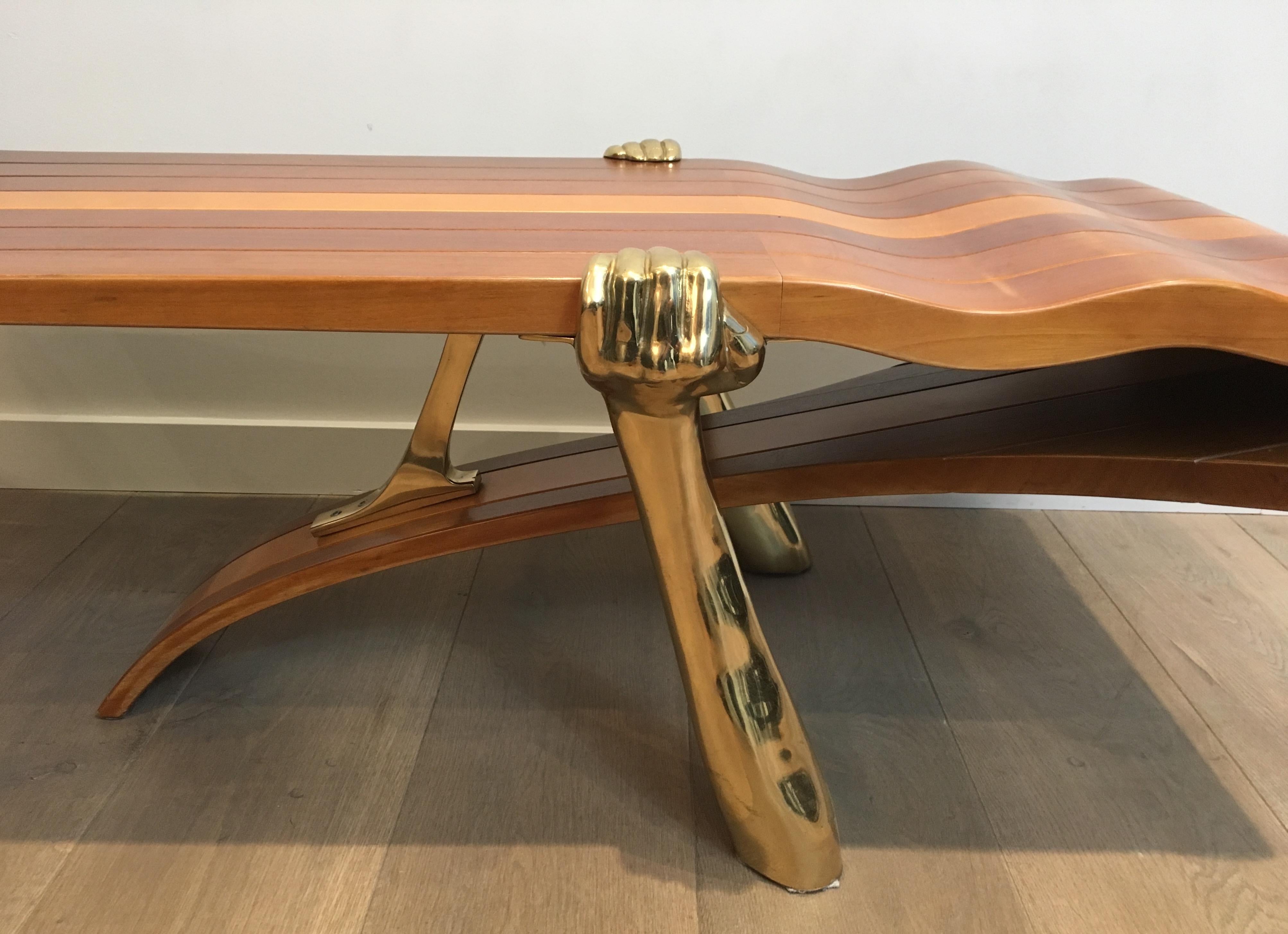 Gilt Unique Coffee Table Made of a Thick Freeform Wood Top Supported by Brass Arms For Sale