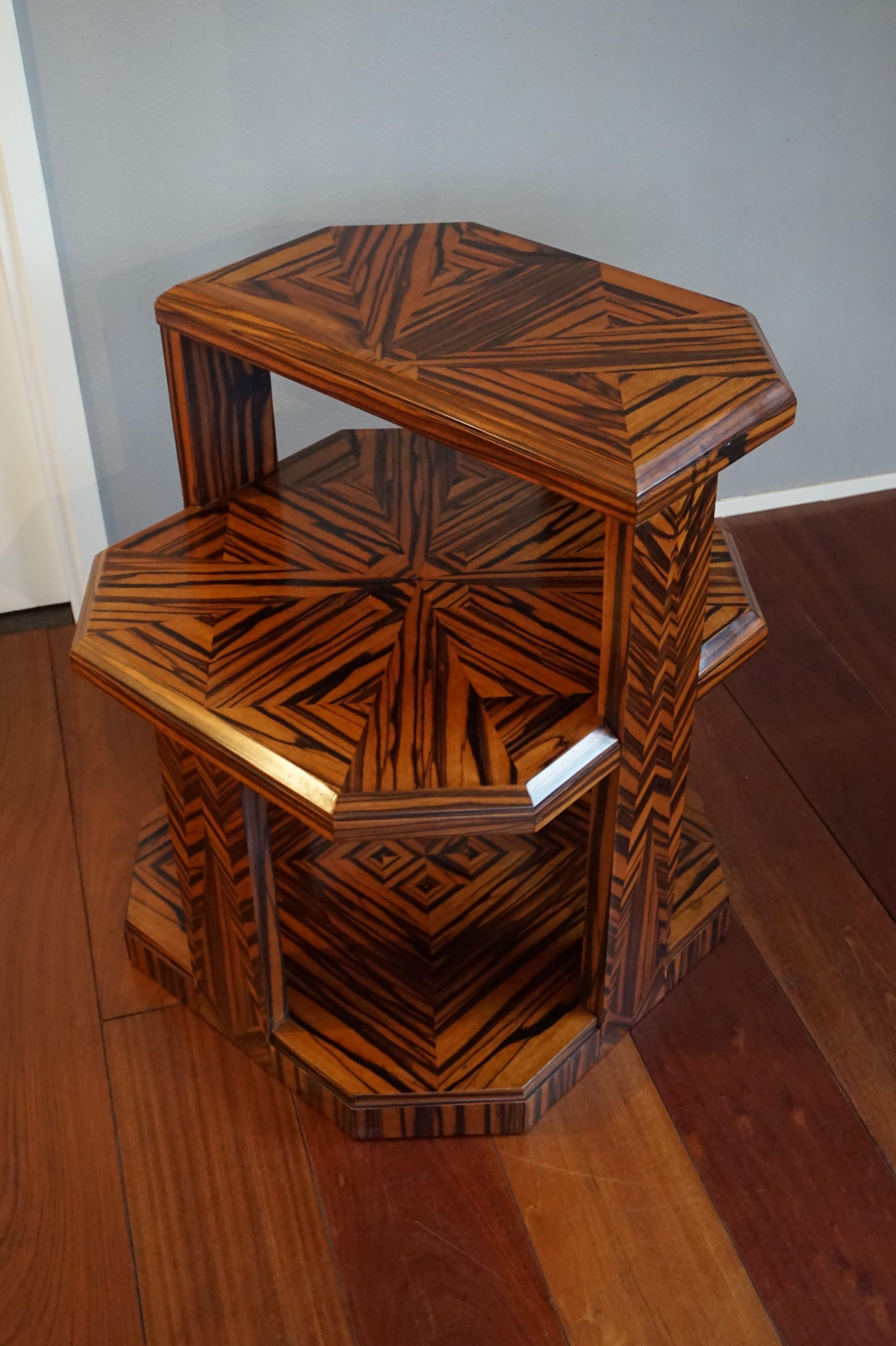 Marvellous Art Deco table with the wow-factor.

Antiques made of real Ceylon coromandel are a rare find. This Art Deco étagère is not only made of this striking, tropical wood, it is also inlaid with the most amazing geometrical motifs. In our view,