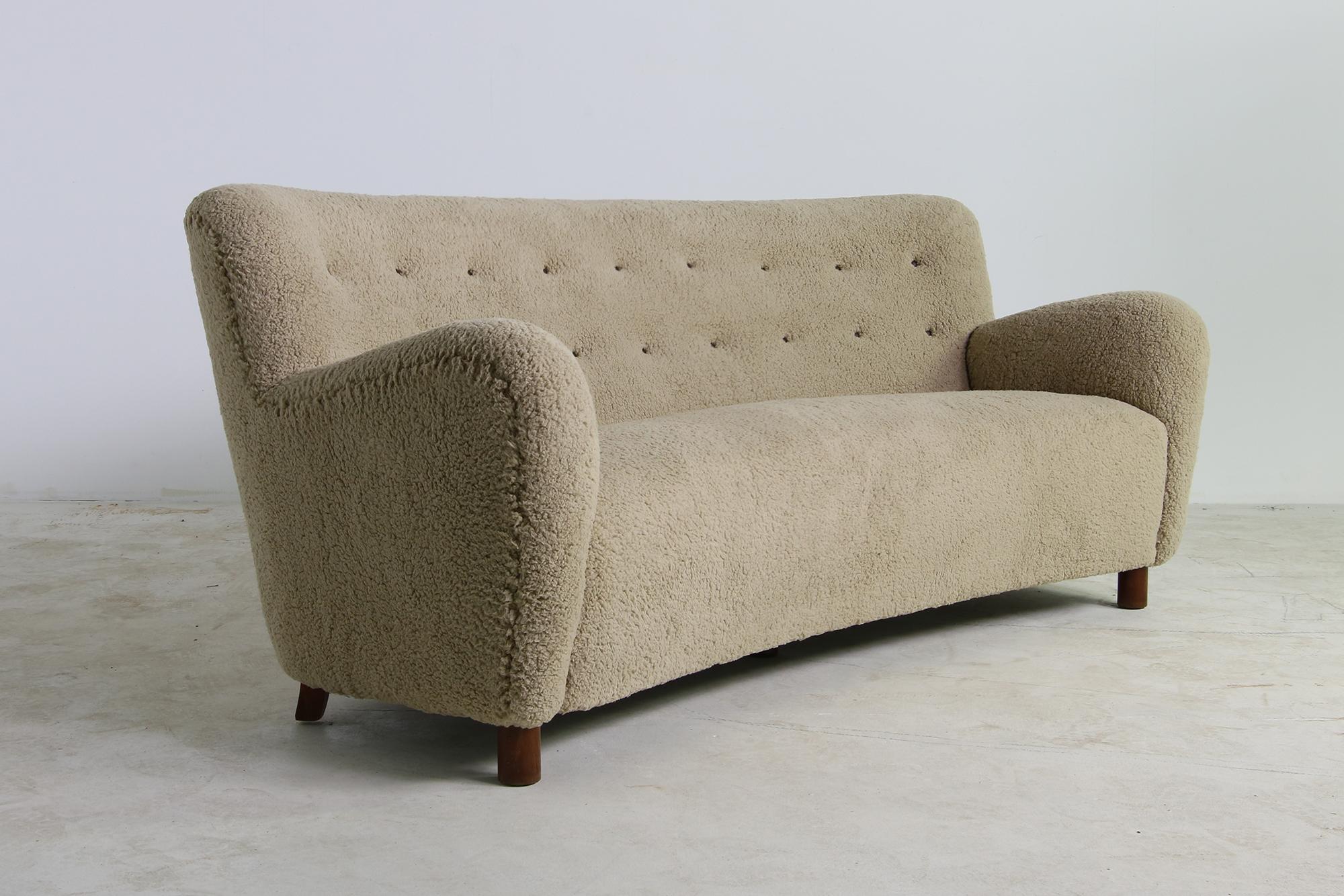 Beautiful authentic midcentury sofa, curved. Purchased in 1949 in Denmark, design attrib. to Mogens Lassen, typically round legs in the front and edgy legs in the back. Best condition, new upholstery and new eaerthy tone teddy fur fabric, like