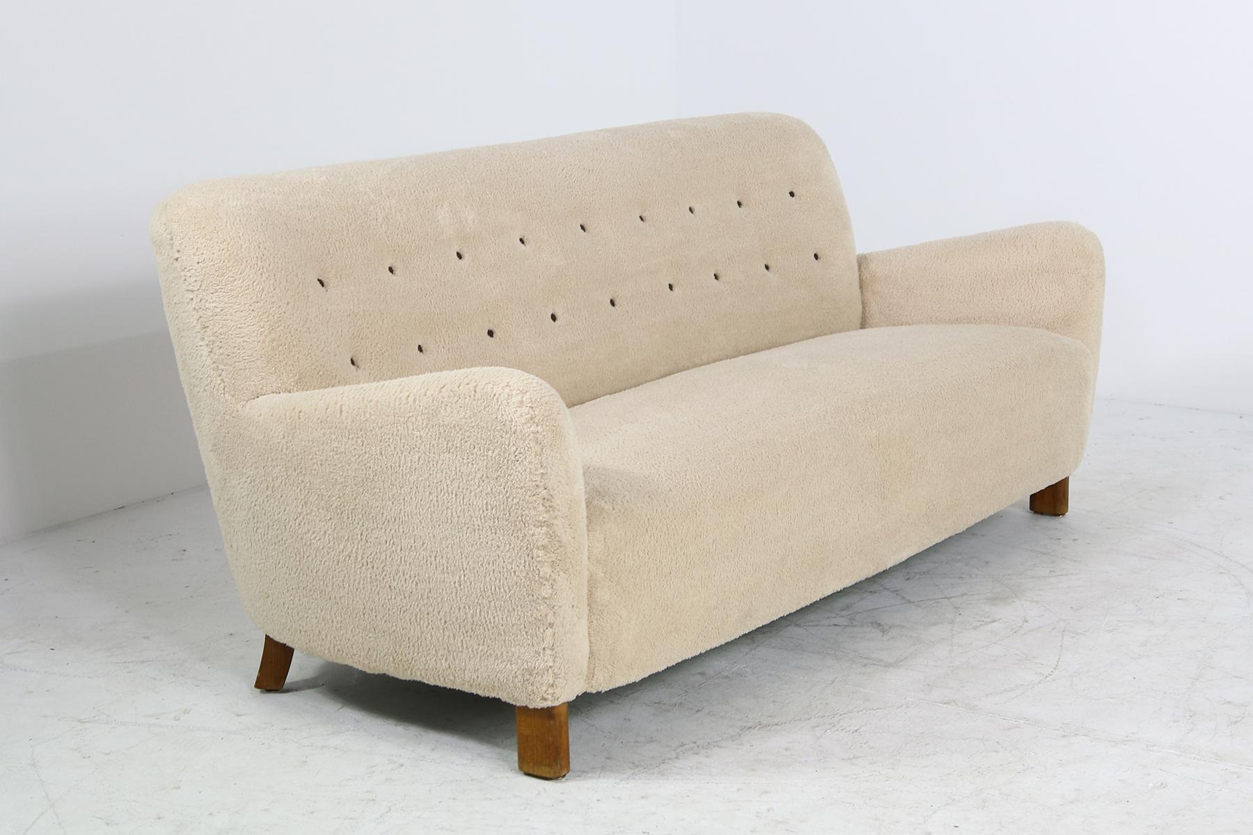 Beautiful and in this style, unique Fritz Hansen sofa 1669, solid beechwood legs, completely reupholstered and professionally renewed upholstery, since this time, never used, the condition is amazing, the fabric super soft, real leather buttons