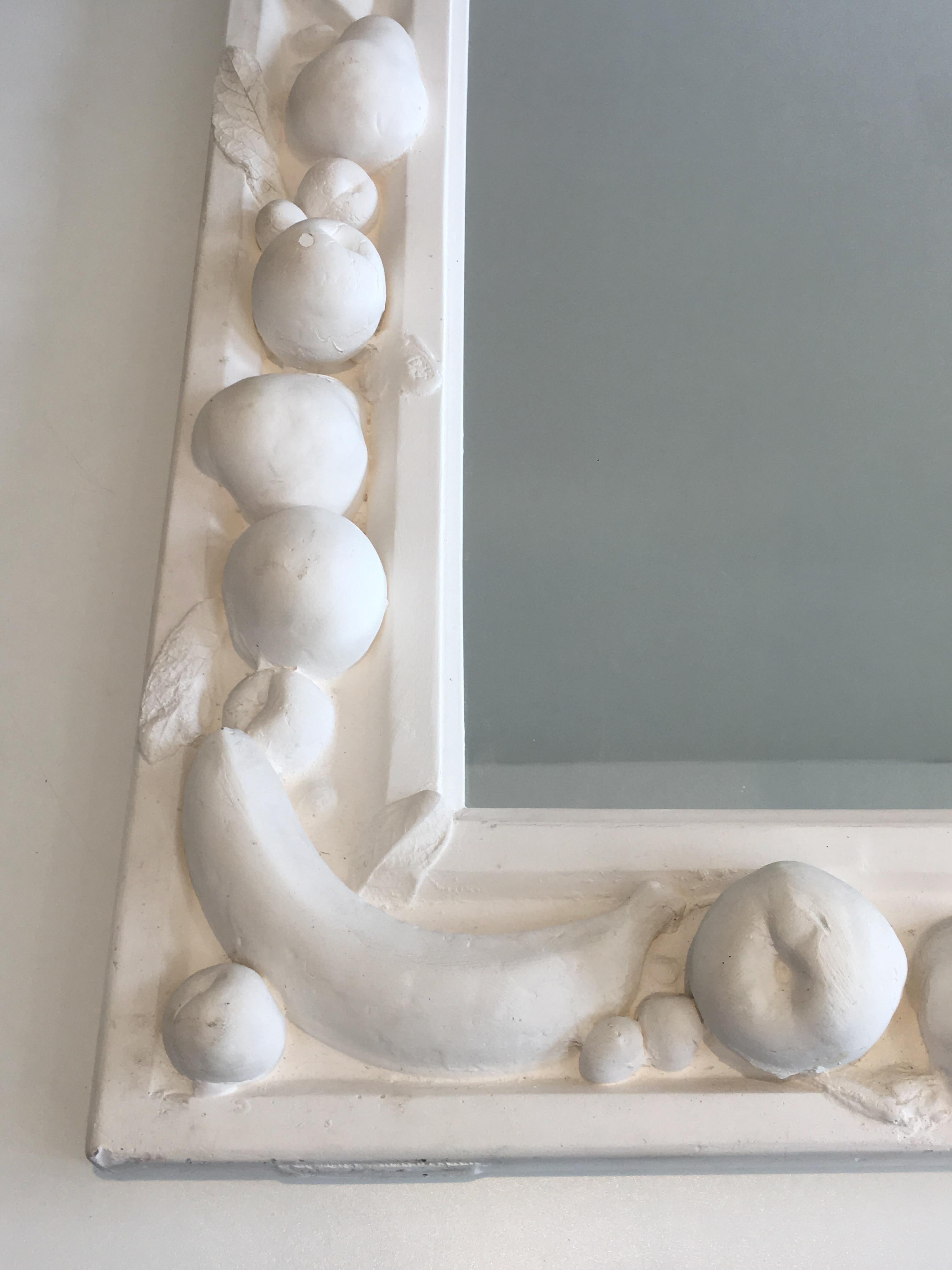 This unique decorative mirror is made of plaster. This is a beautiful piece with fruits decors. This is a French work, circa 1970.