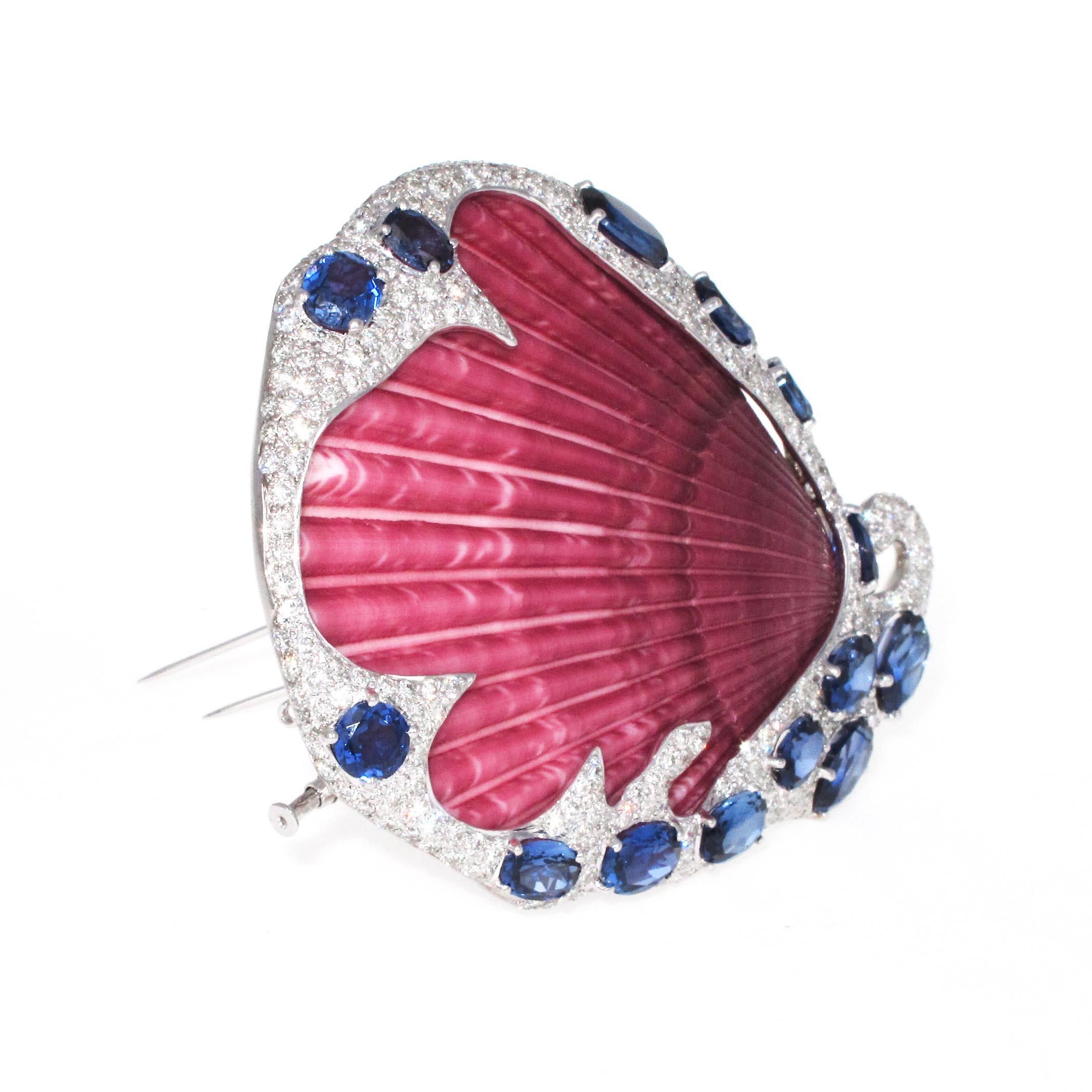 Such a special unique piece. This brooch has a gorgeous pink shell set in the center of it. Around the shell is 8.08 carats of high color and clarity white diamonds. We estimate them to be E/F in color and VS/Si in clarity. The larger stones are