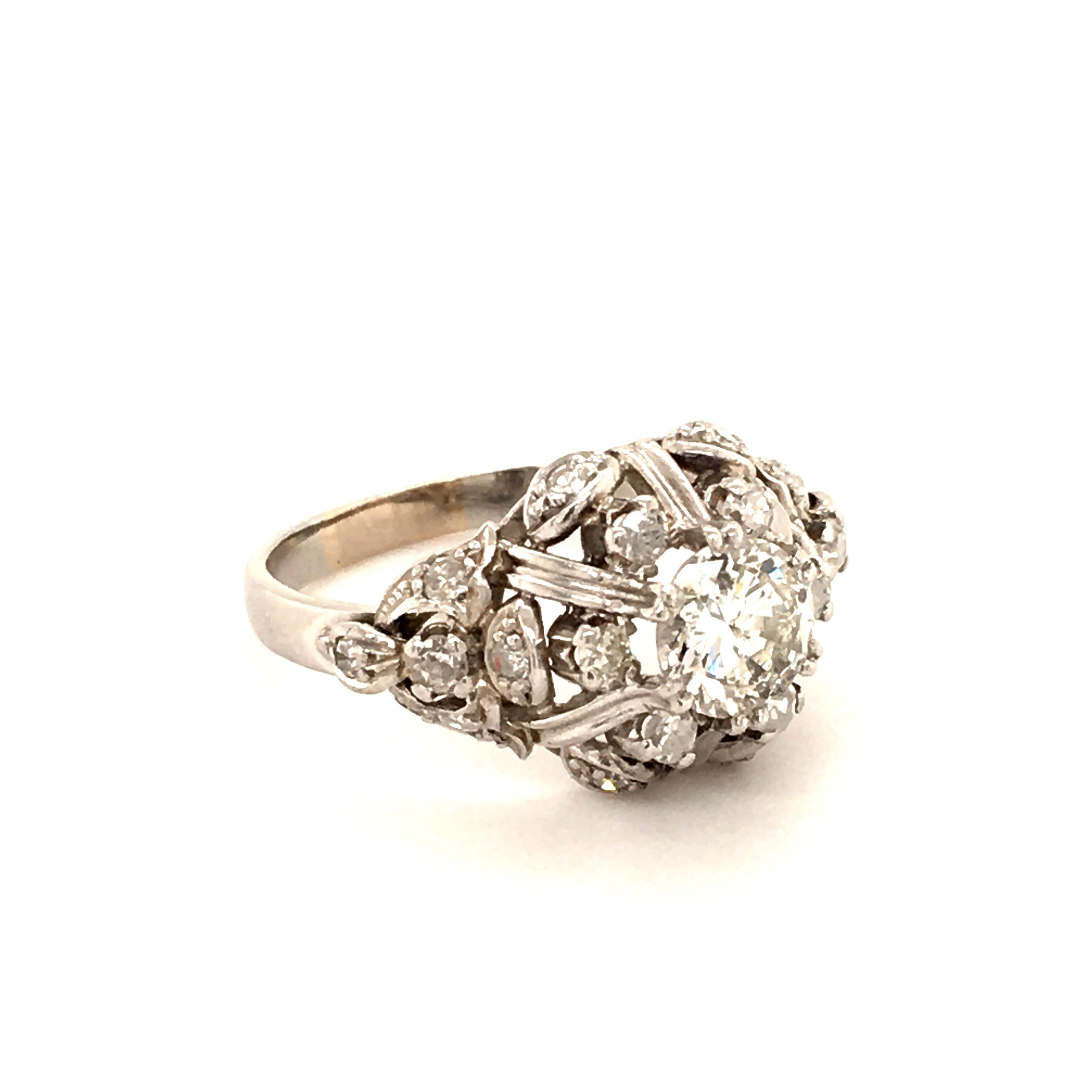 This playful ring in platinum is set in the center with a round brilliant-cut diamond of 0.84 ct which is of H/I-I1 quality. The ornate and complex mounting is decorated with 20 single-cut diamonds totalling 0.48 ct.
Ring band is engraved with