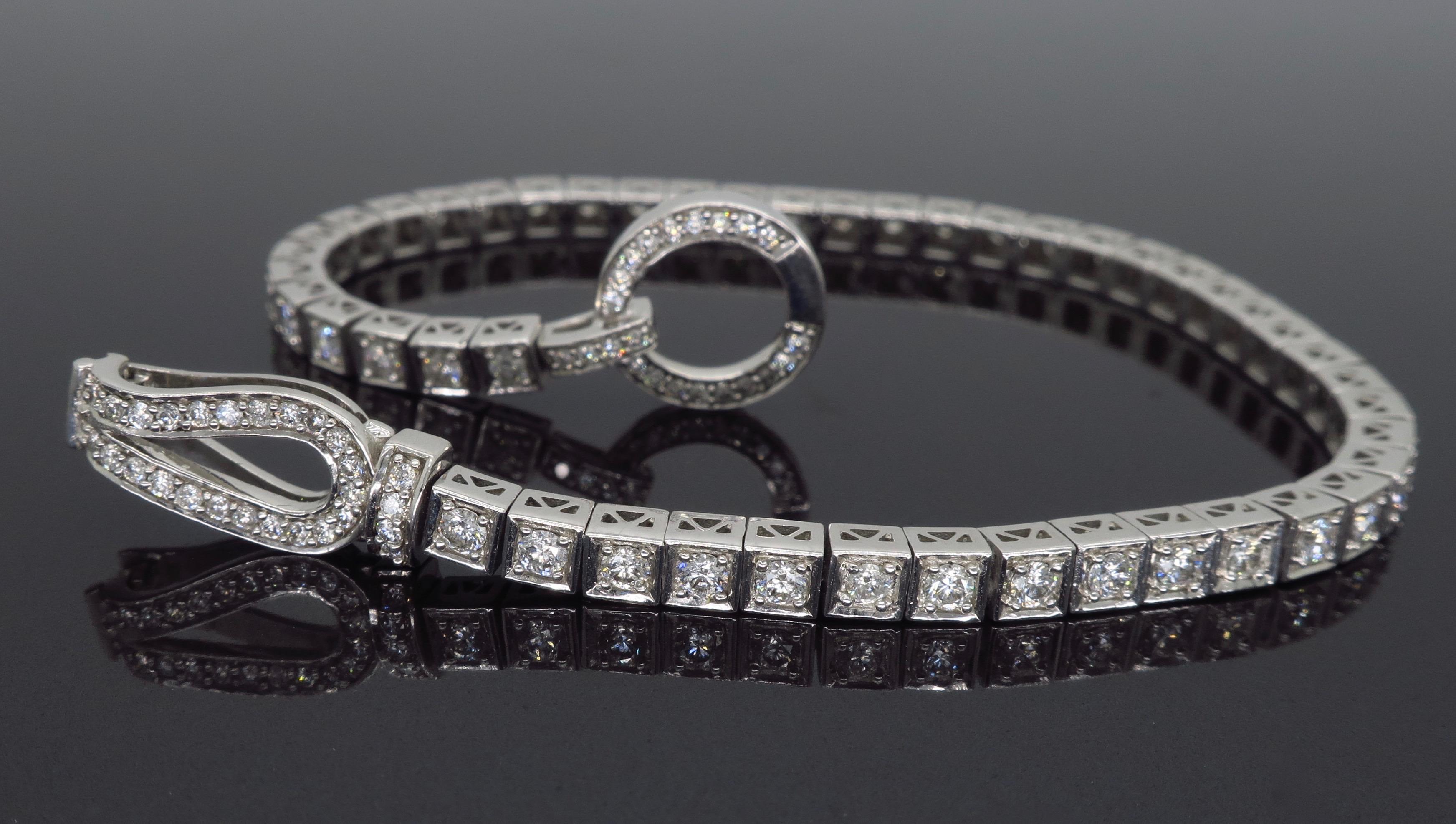 This stunning tennis bracelet features 96 Round Brilliant Cut Diamonds, set in 14K white gold with a unique clasp.

Diamond Carat Weight: Approximately 2.00CTW
Diamond Cut: 96 Round Brilliant Cut Diamonds
Color: Average G-I
Clarity: Average