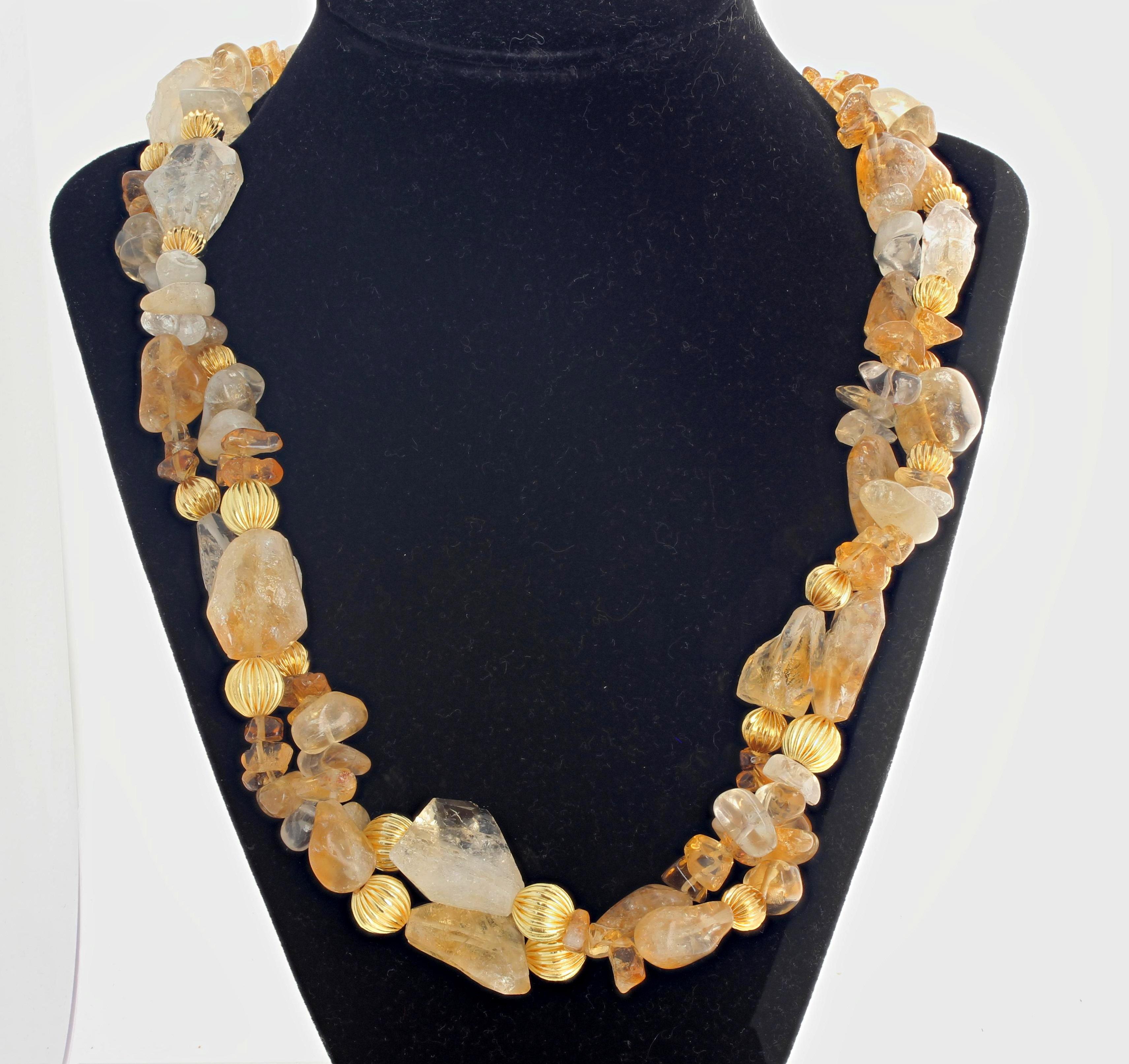 This double strand golden necklace of highly polished natural Citrine rocks accented with golden rondels is 22 inches long set with an easy to use gold plated hook clasp.  The largest Citrine is 22 mm x 18 mm.  This is dramatic for daytime to