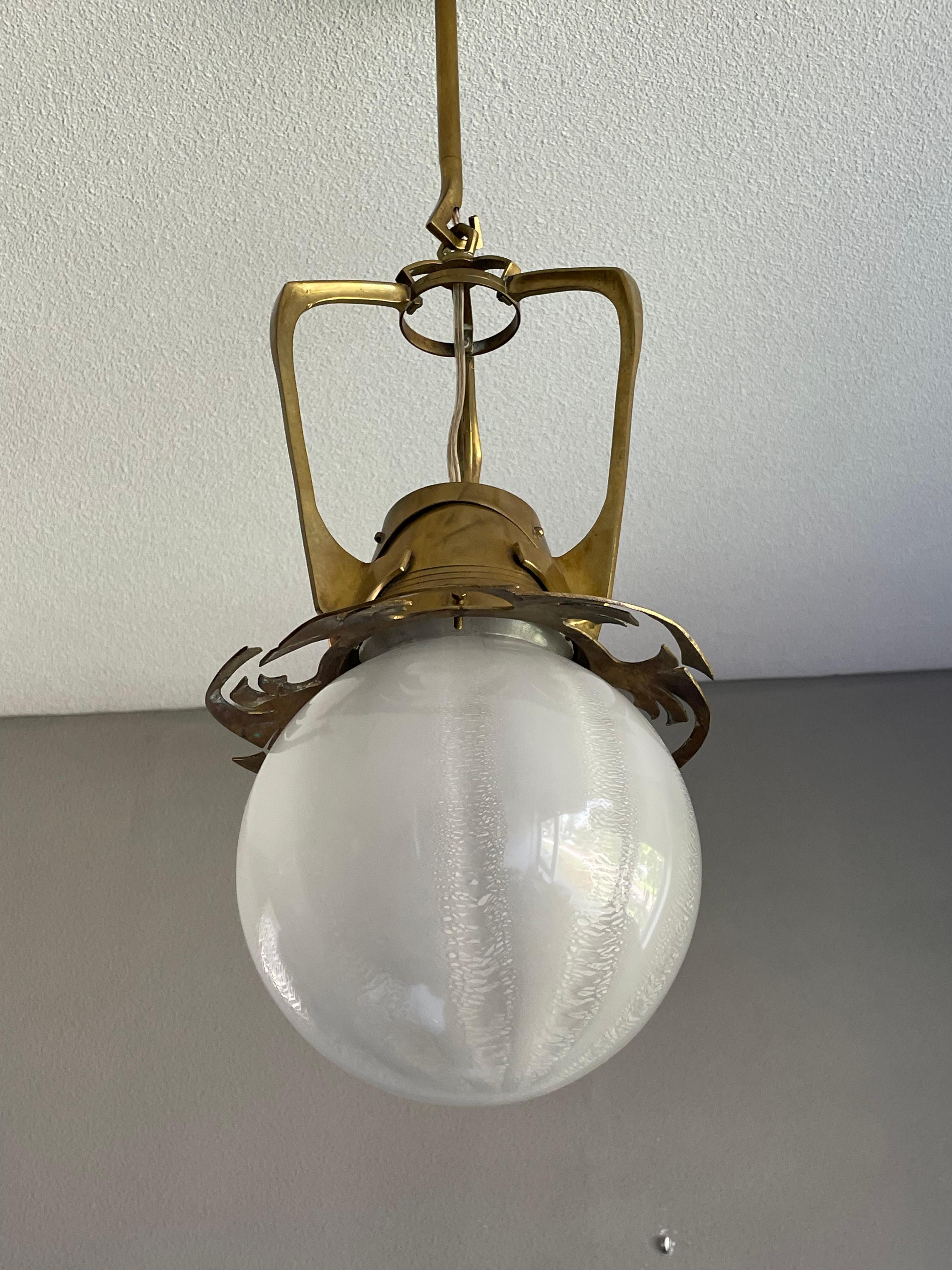 Marvelous design and truly unique Dutch Arts and Crafts pendant.

With early 20th century light fixtures being one of our specialities, finding an Arts and Crafts pendant as unique as this always makes our heart jump. Every designer knows that