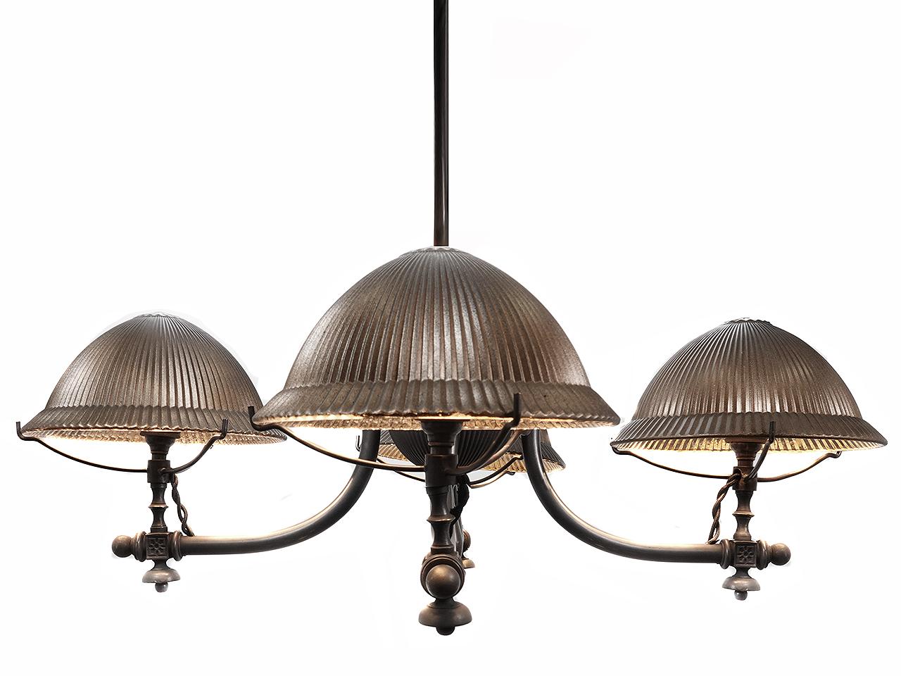 This is a very interesting and early gas lamp that we have wired to now take candelabra bulbs. There are 4 very unique fluted prismatic dome shades with the original mercury glass mirror. Note that the pattern on the glass and brass center ball