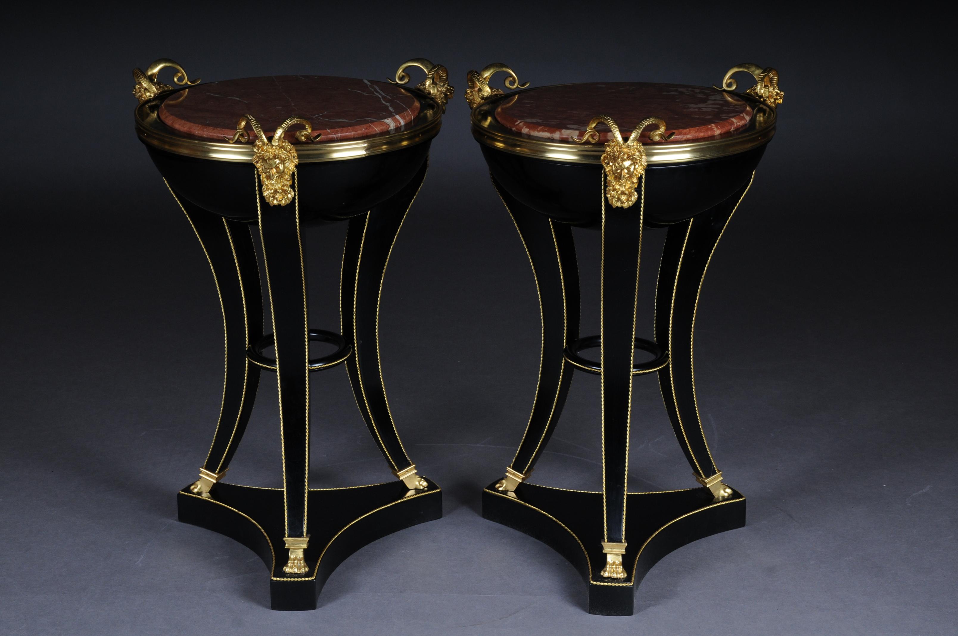 Unique ebonized side table in the Empire style

Piano black polished veneer on solid wood. Hemisphere with marble slab on satyr mask with tapered curly square legs in bronze lion paws ending on base plate retracted on three sides. The fittings are