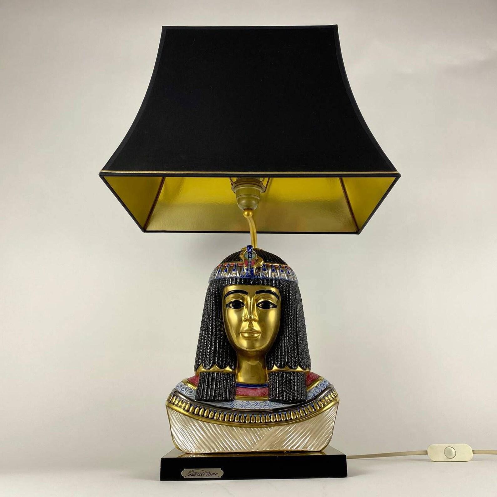 Stunning Italian Capodimonte porcelain table lamp in Hollywood Regency Style depicting Egyptian Queen Nefertiti. 

  Amazing detailed chiseled features and head piece's, wonderful patina.

 Signed Edoardo Tasca.

  Rectangular base. Black fabric