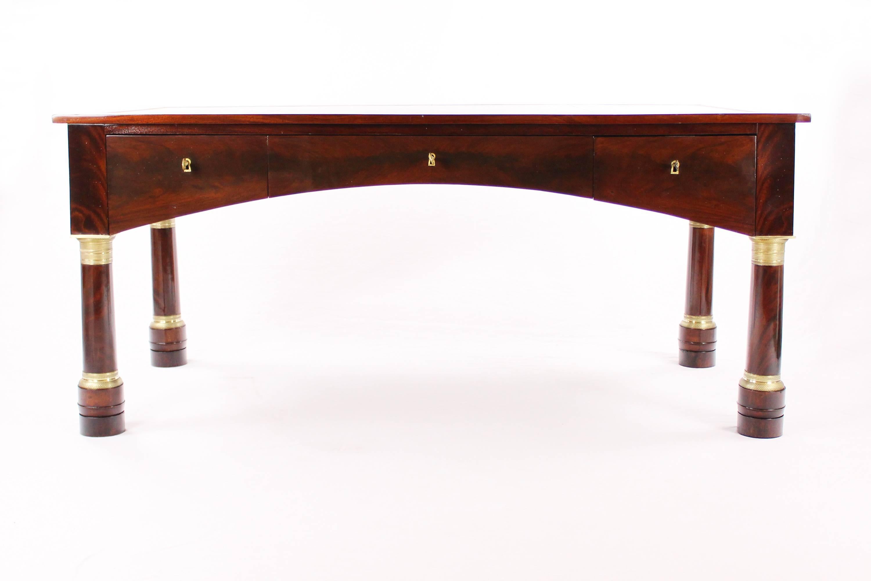 • Unique Empire desk
• Mahogany veneered
• France, circa 1810
• Writing surface with leather insert
• Extendable sides
• Three pushes
• Key sockets with brass border
• Massive column legs with brass capitals and brass tapes
• Restored