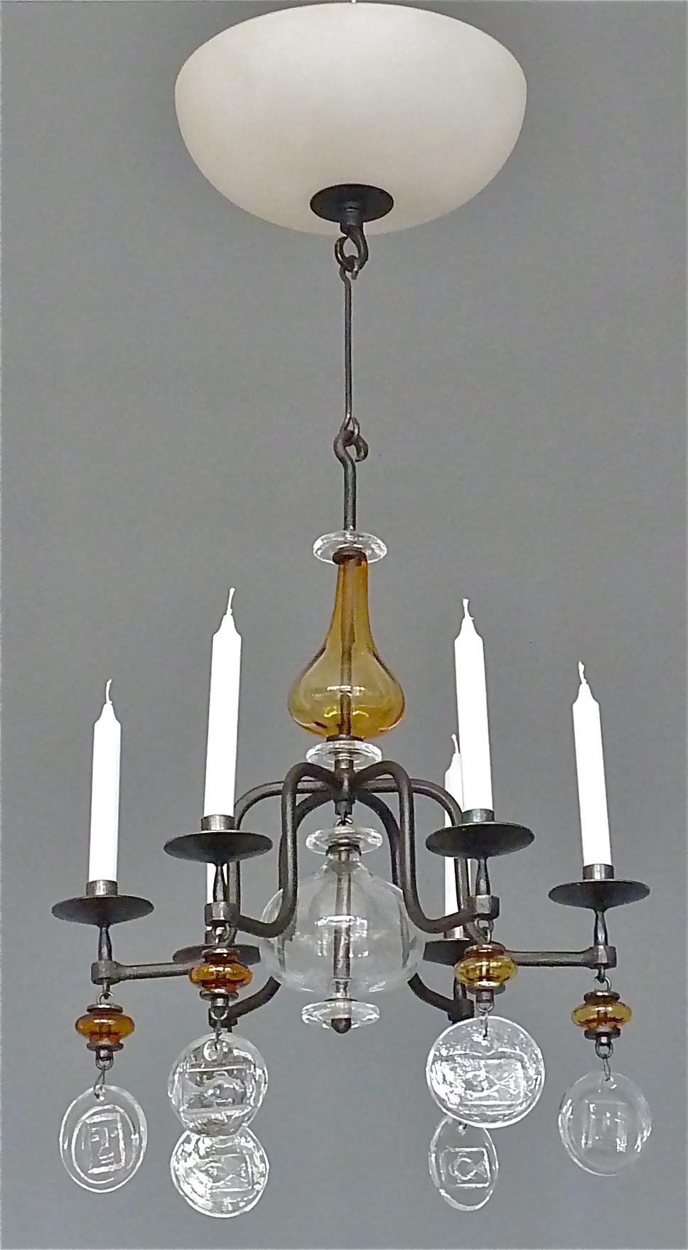 Beautiful and rare Scandinavian Modern electrified six-arm black wrought iron chandelier designed by the famous artist Erik Höglund and executed by Boda Nova Glassworks / Axel Stromberg Ironworks, Sweden, circa 1960-1970. The chandelier has clear