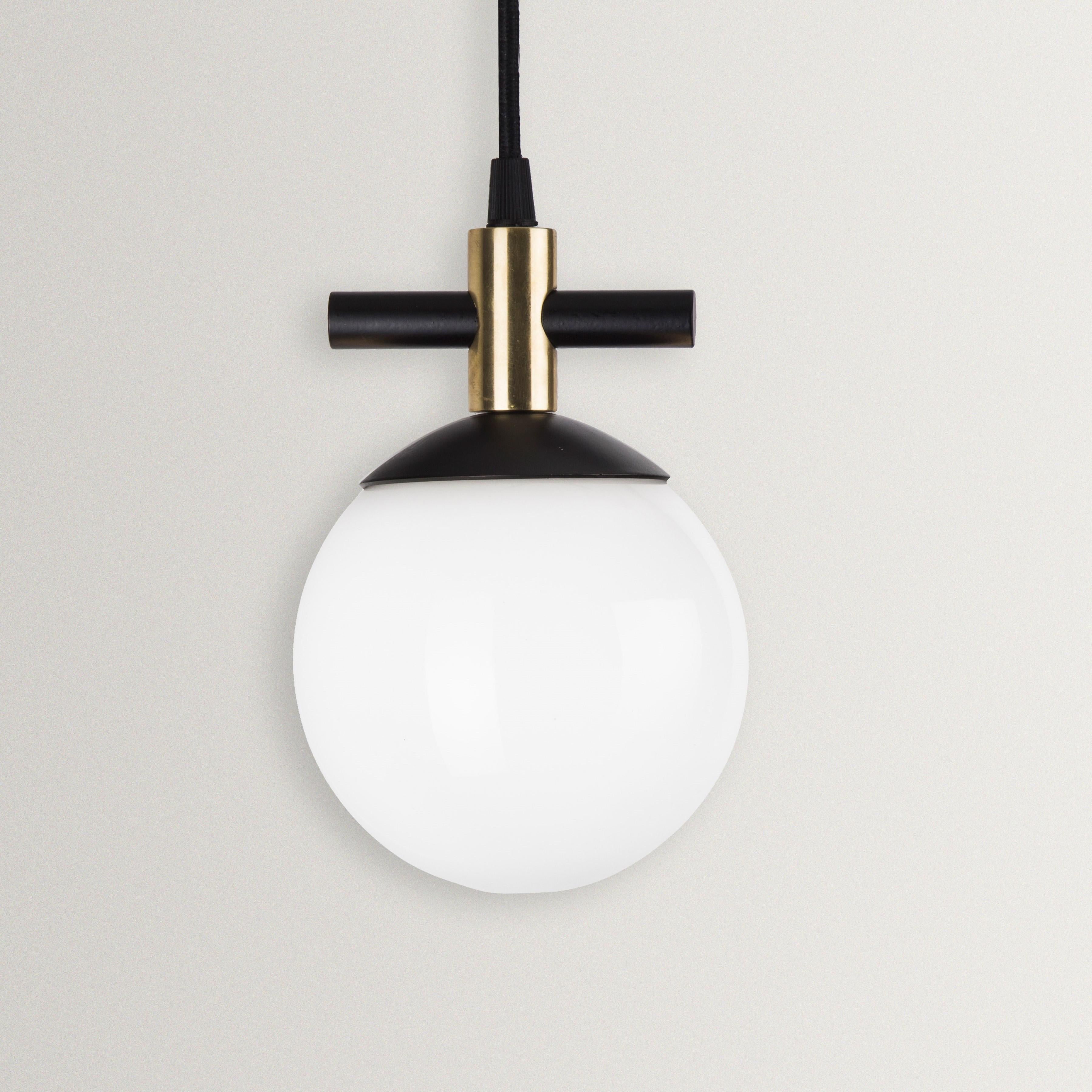 Unique Esferra pendant by Hatsu
Dimensions: W 14 x H 19 cm 
Materials: Opal glass with powdercoated aluminium

Hatsu is a design studio based in Mumbai that creates modern lighting that are unique and immediately recognisable. We started with an