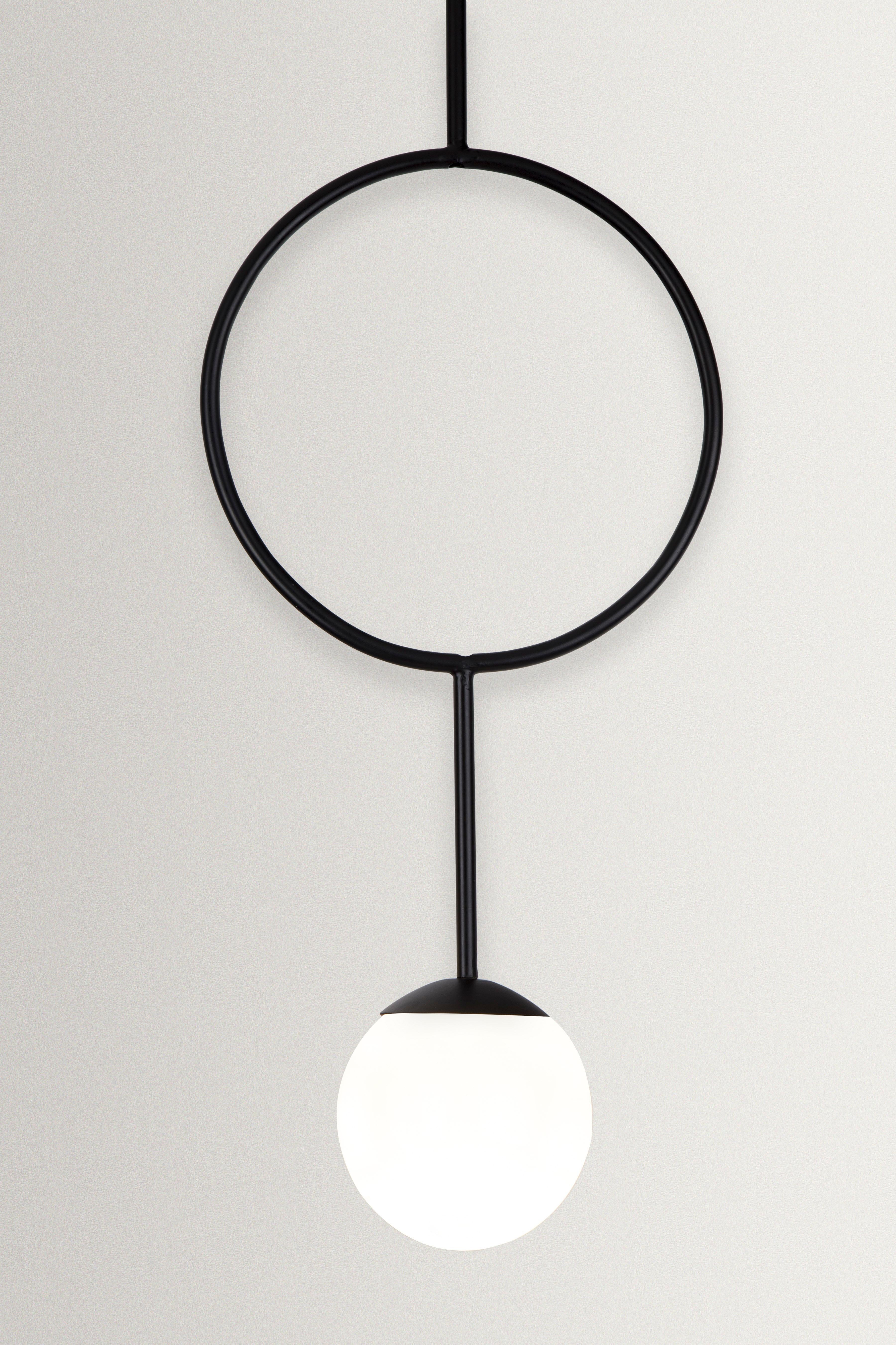 Unique Esferra ring pendant by Hatsu
Dimensions: W 25 x H 65 cm 
Materials: Opal glass with powder coated aluminium

Hatsu is a design studio based in Mumbai that creates modern lighting that are unique and immediately recognisable. We started