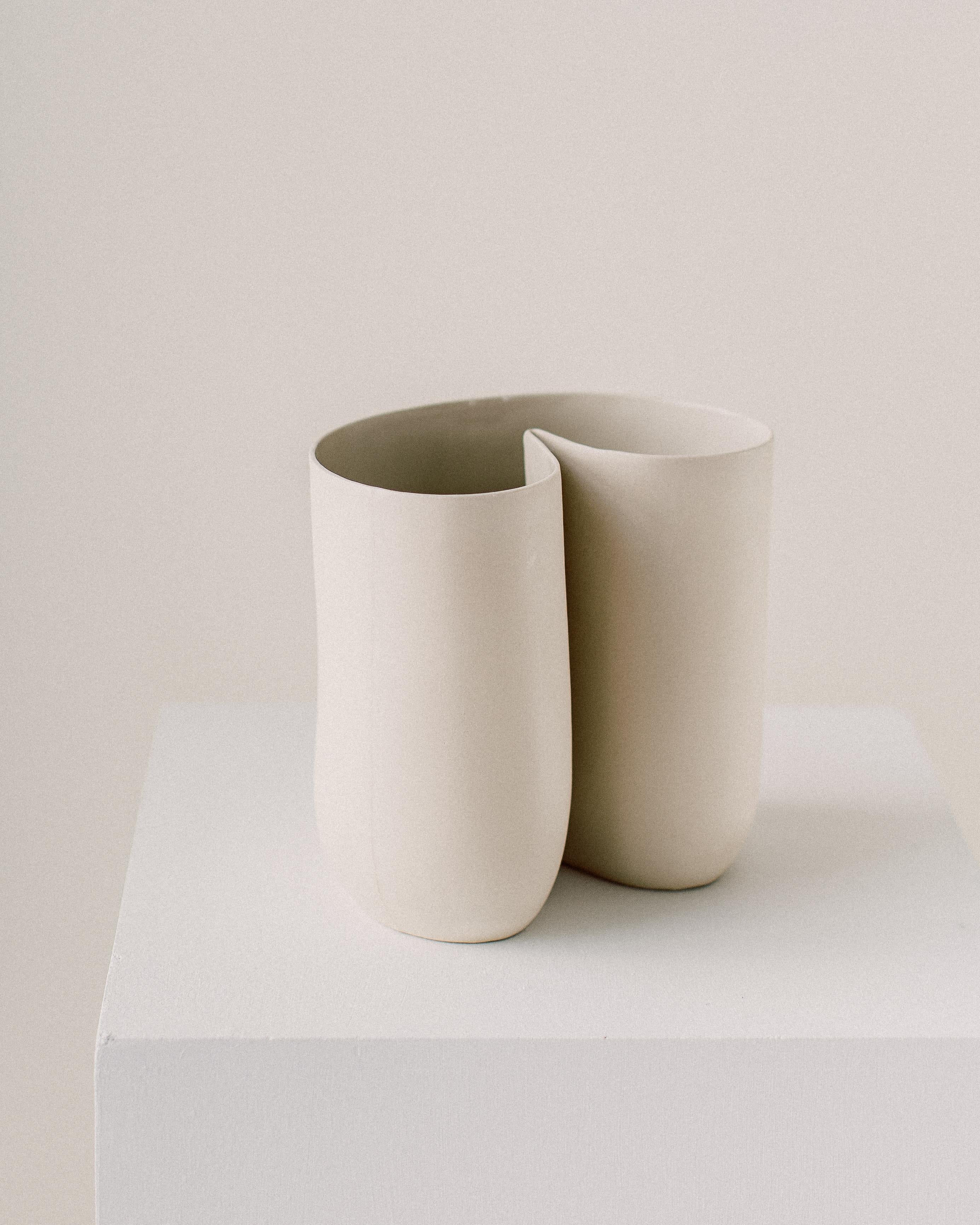 Unique esse vessel by Dust and Form
Dimensions: W 14 x D 20.3 x 19 H cm
Materials: Porcelain

Origin Form Collection in three finishes: Hand-sanded (our classic, smooth, bare finish) Ivory (satin white glaze) Charcoal (matte black glaze). Please