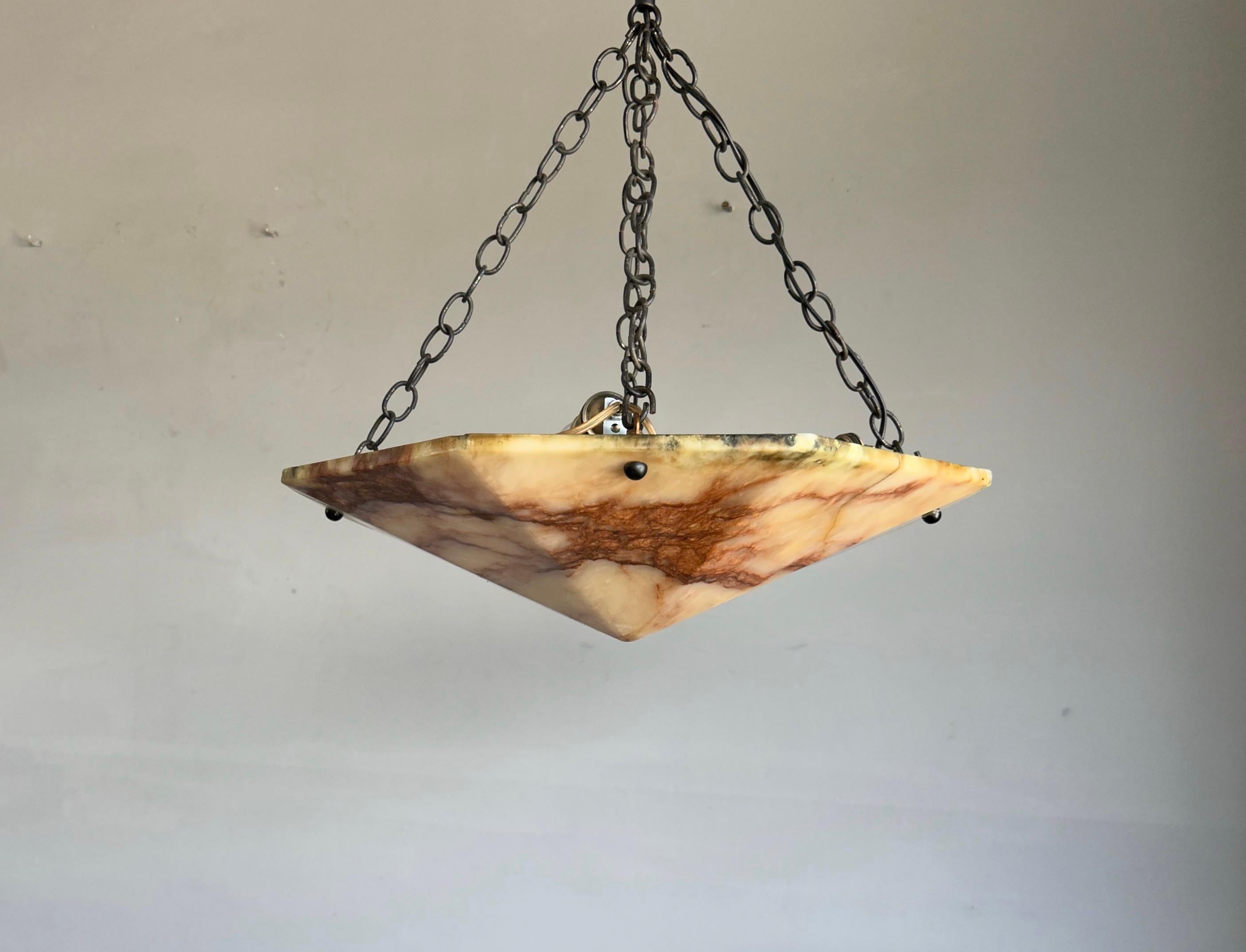 Stunning geometrical Art Deco design alabaster light fixture.

This pure and large size Art Deco pendant from the early 1900s is an absolute joy to come home to. The rare and beautiful, diamond shape alabaster shade is perfectly complemented by the