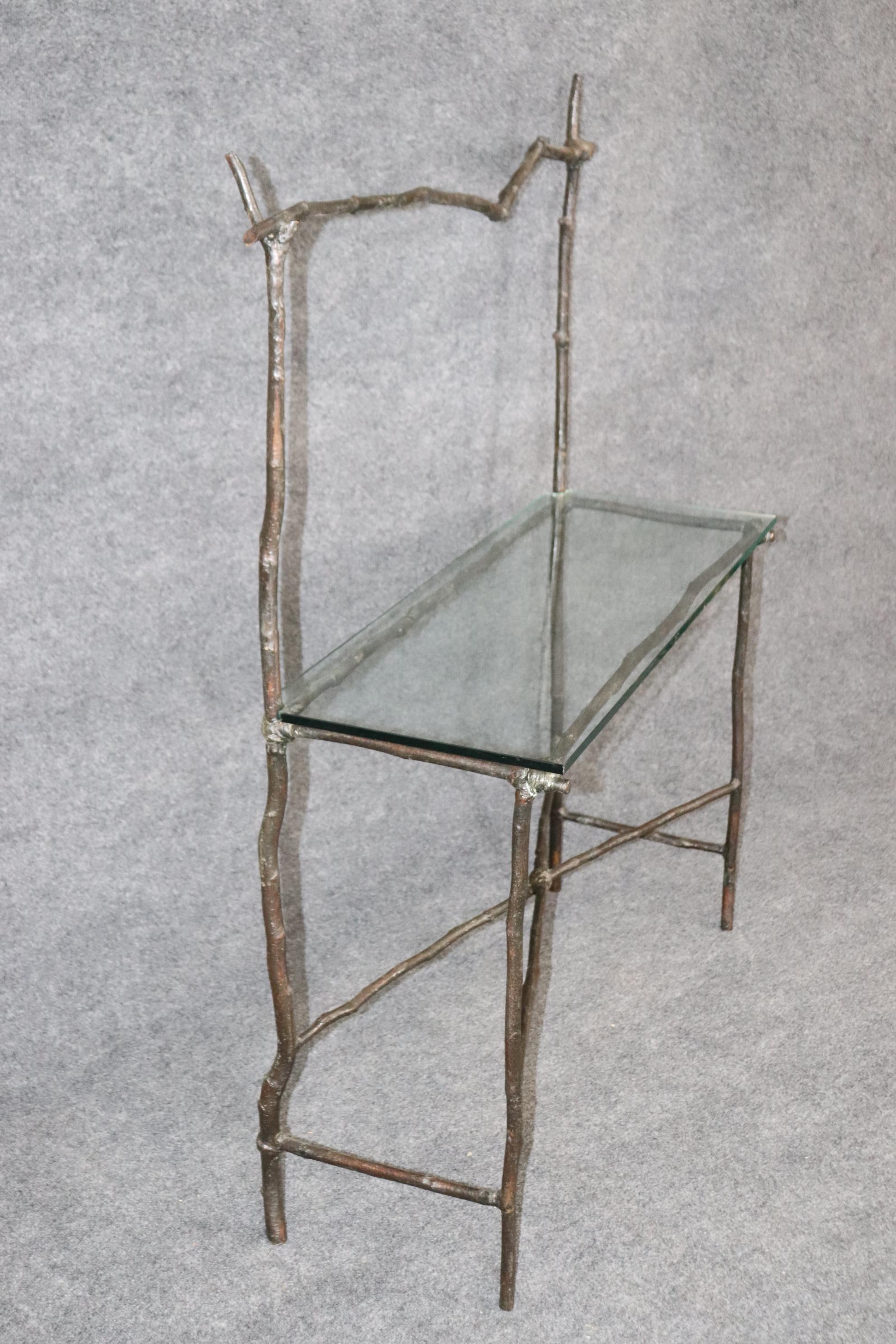 This is a unique faux bois twig form Giacometti style console table. The table has some chips on the glass which can be lived with or polished out at a glass shop. The table Measures 53.5 tall x 43.75 wide x 15 deep. Dates to teh 1960-70s era. 