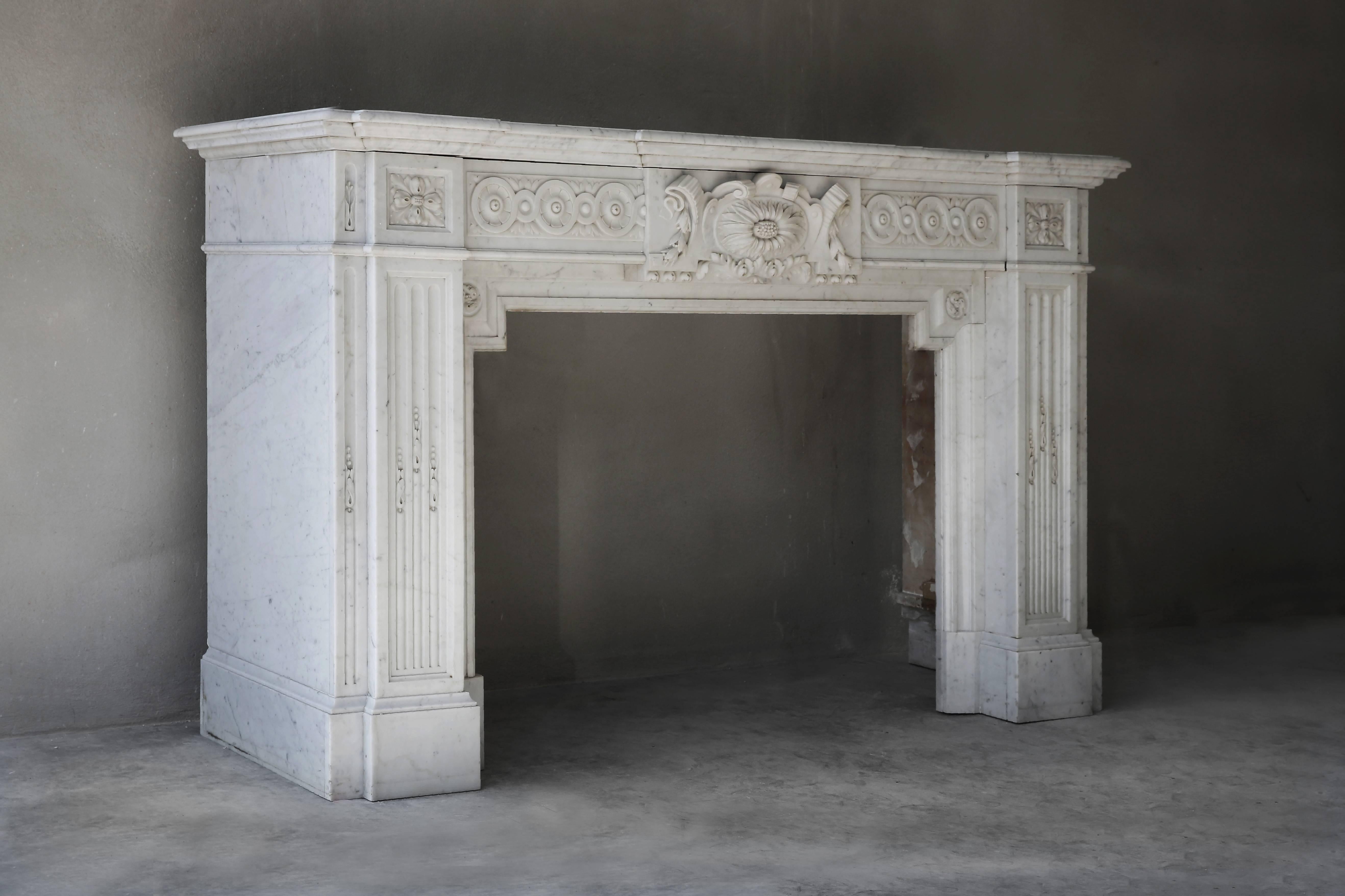 A very unique and exclusive antique mantelpiece made of Carrara marble from the quarries of Carrara, a village in Italy. Carrara is a very exclusive and beautiful type of marble. This neo-classistic chimney is of high quality, dates from the period