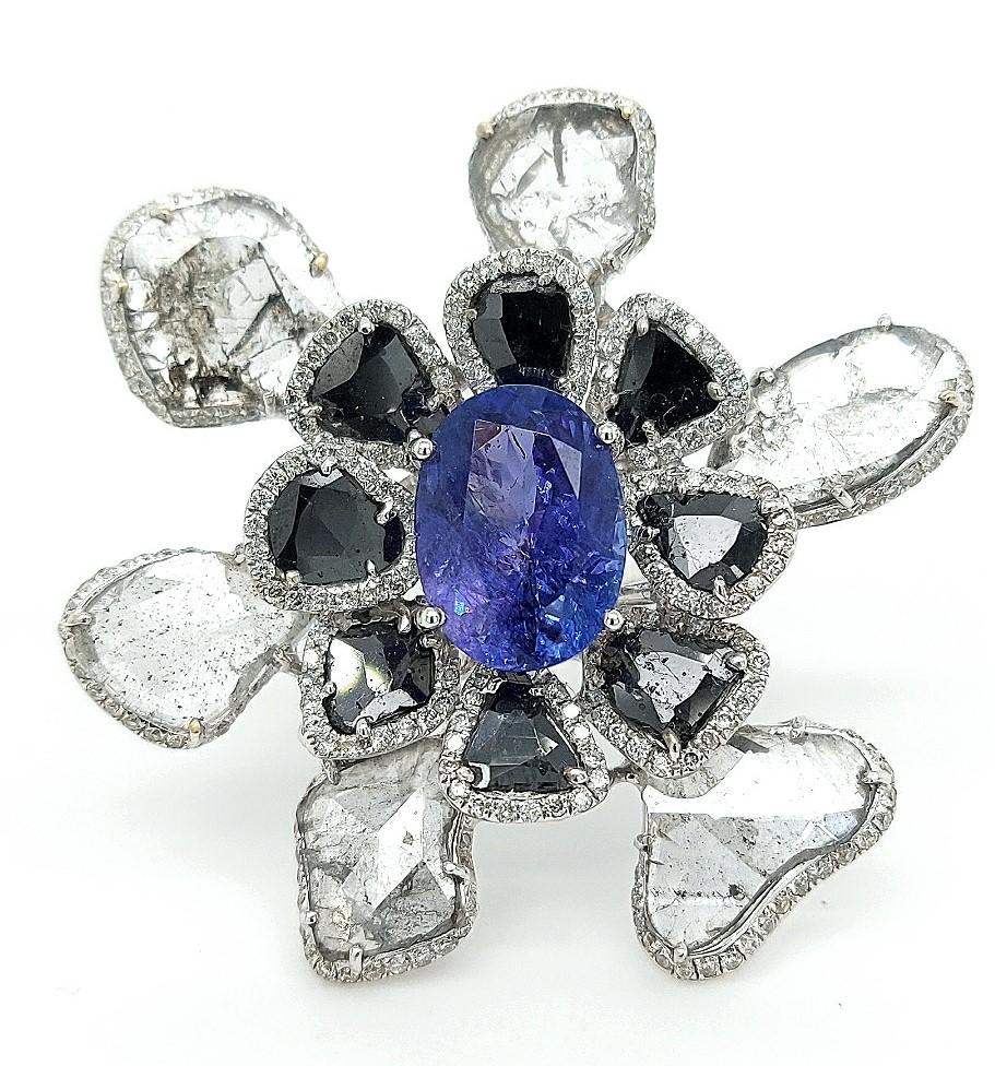 Unique Flower Ring with Tanzanite and diamonds

One of  a kind and unique creation.

You see right away a real artist made it .

Stones : Tanzanite ca.5,5 ct / Diamonds : White brilliant cut diamonds ca. 2,56 ct +Black Rose cut diamonds  ca.3,4 ct +