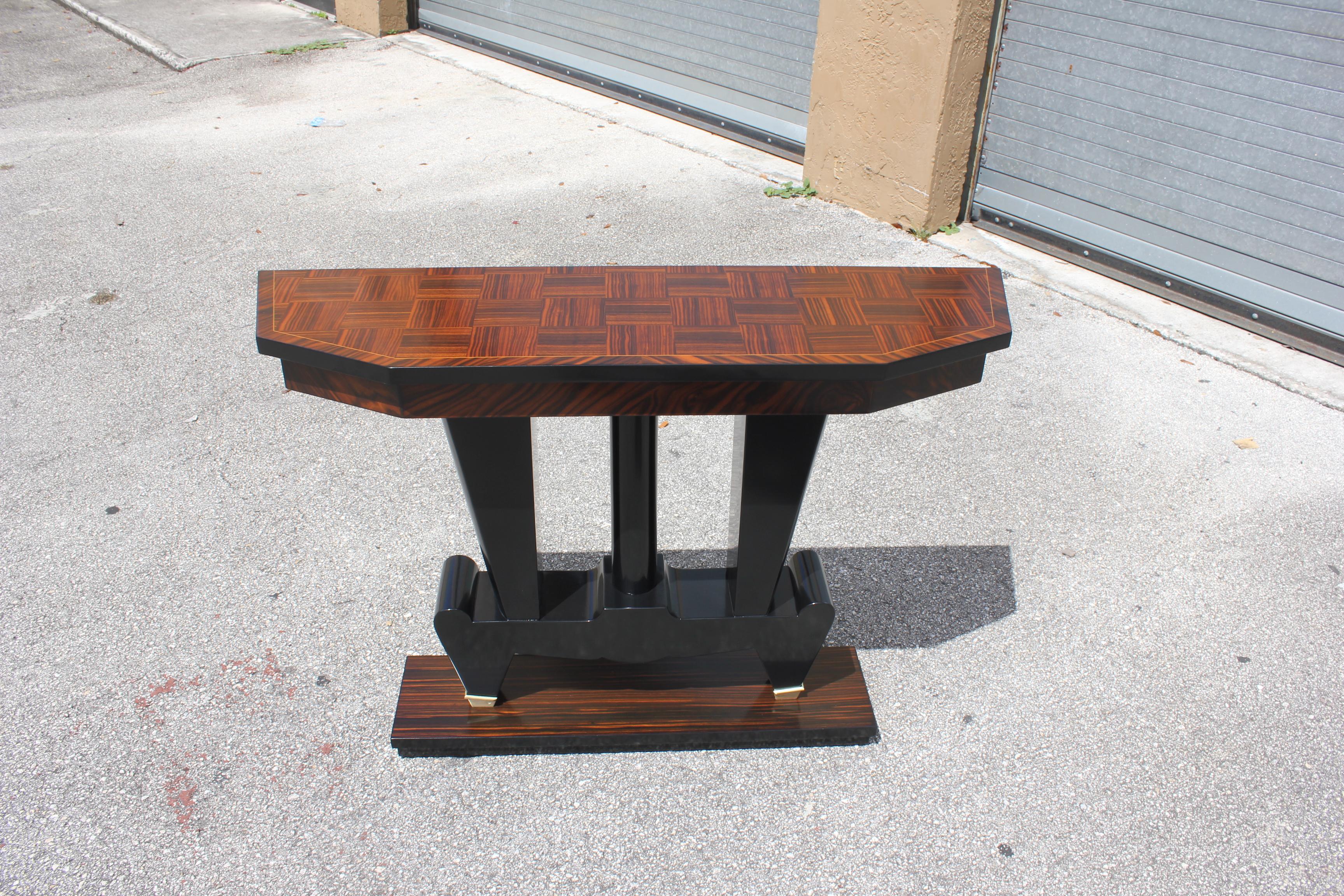 Beautiful French Art Deco exotic Macassar ebony console tables, circa 1940s. Beautiful Macassar ebony with black lacquer centre base, finish in both side, beautiful bronze hardware detail, that rest on makes it ideal for use as a bedside table or