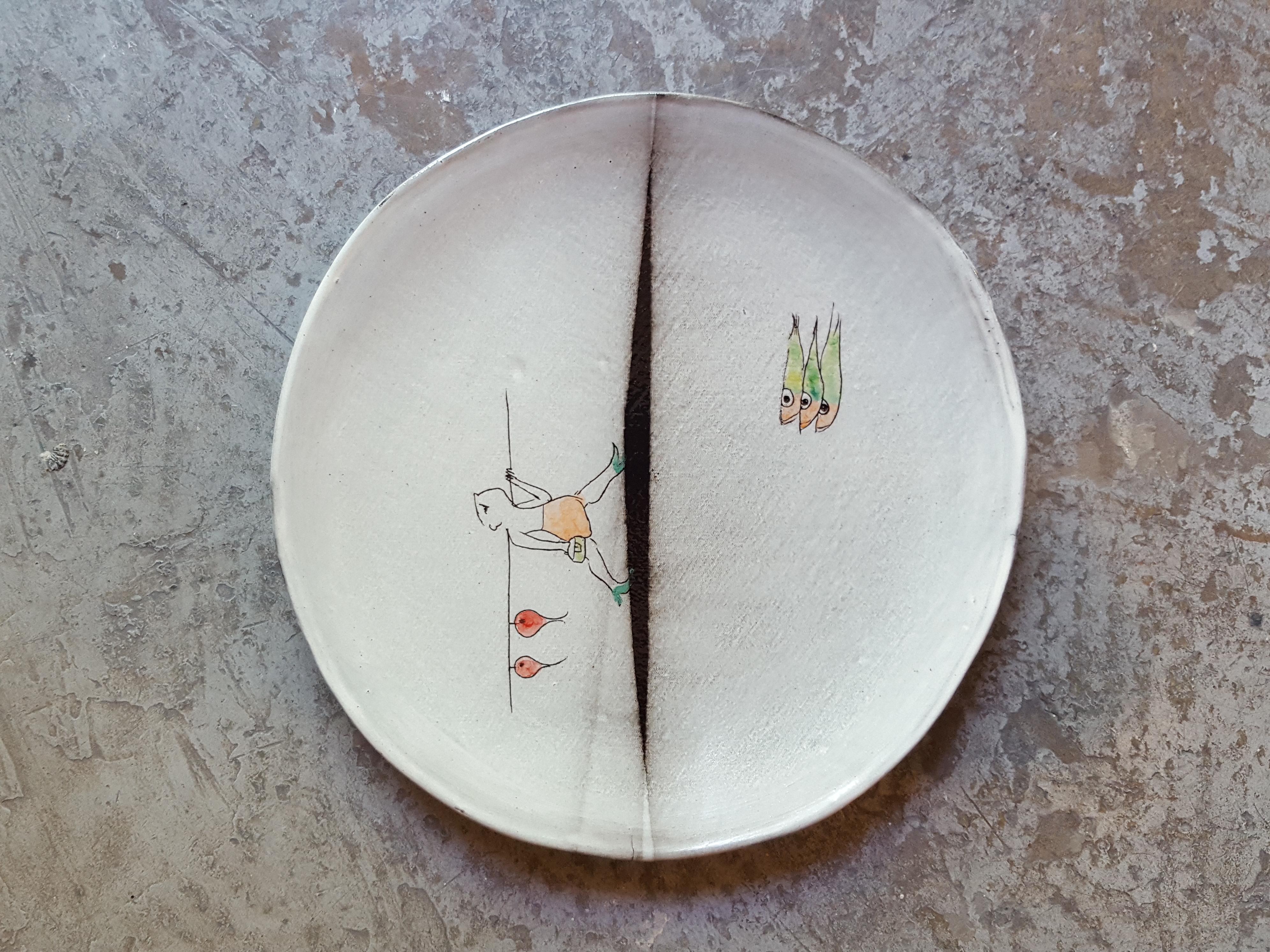 Ceramic earthenware Faience dinner plate artist creation, all handmade in France.
Using plaques of dark Faience, graffiti, paint and enamel.
Decoration hand-painted with the artist's creative poetic characters limited edition.
There are different