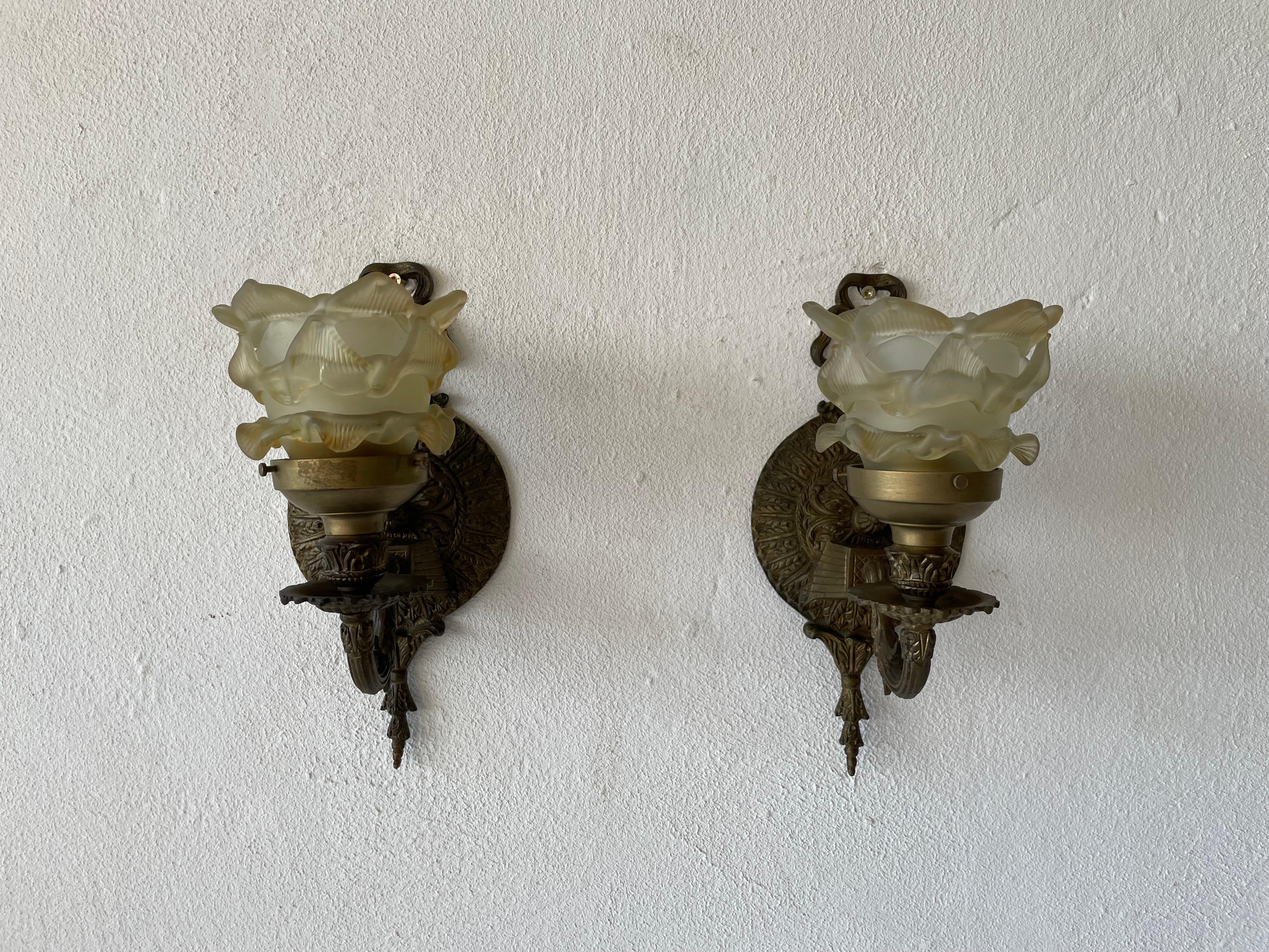 Unique French flower shaped smoke glass & brass pair of sconces, 1940s, France

Very elegant wall lamps
Lamp is in very good condition.

These lamps works with E27 standard light bulbs. 
Wired and suitable to use in all countries. (110-220