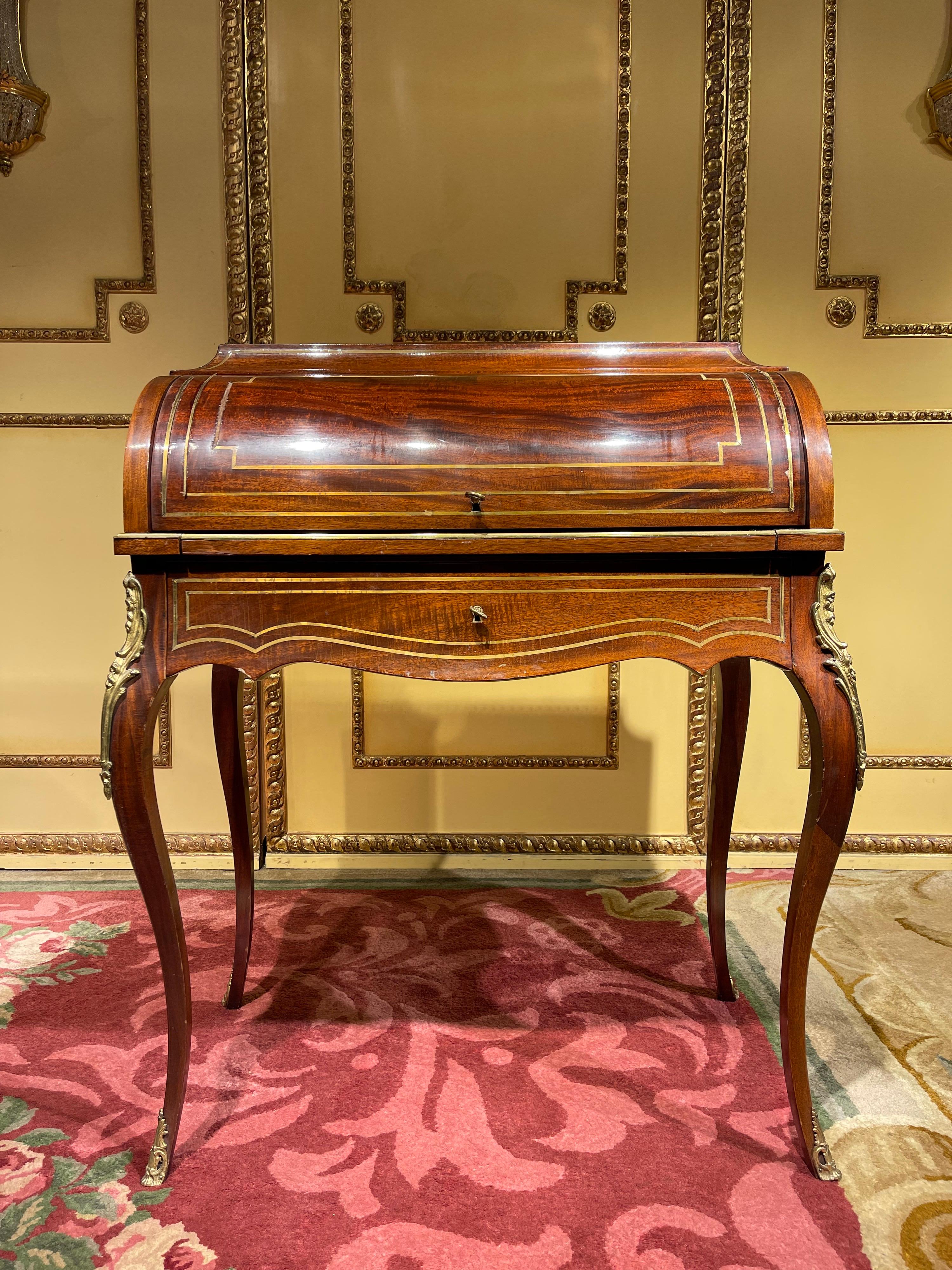 Unique French roll-up secretary/desk in the transition style from around 1890

Mahogany and brass inlays. Writing surface and compartments can be pulled out under roller closure. Cut-out frame drawer. brass gallery. Veneered on the back. High