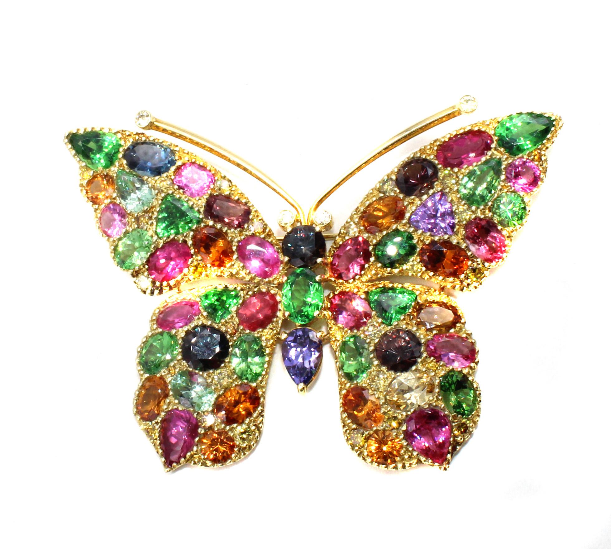 This impressive and unique butterfly brooch has been masterfully handcrafted and designed with over 52 carats of natural gemstones and 1.60 carats of natural yellow and white diamonds. From vivid green Tsavorites, intense orange Mandarin Garnets,