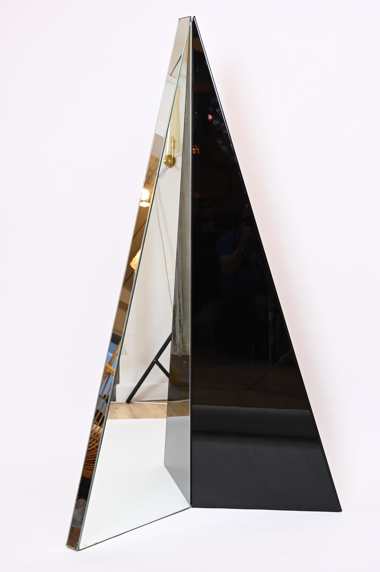 Isosceles triangle that hinges at a vertical bisection. 

One half mirrored on all sides the other black Lucite on all sides

Dimensions: 162cm x 100cm x 5.5cm 
Mirror width is 80cm when standing at right angles.
   
