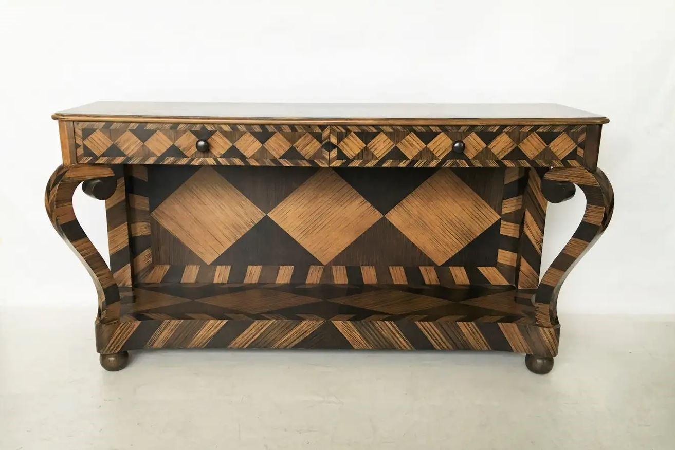 This superb console table showcasing unique modernist geometric marquetry work that brings together Classic design elements and grand scale. Crafted of solid wood, the console has a rectangular top with a flared edge above a case housing two