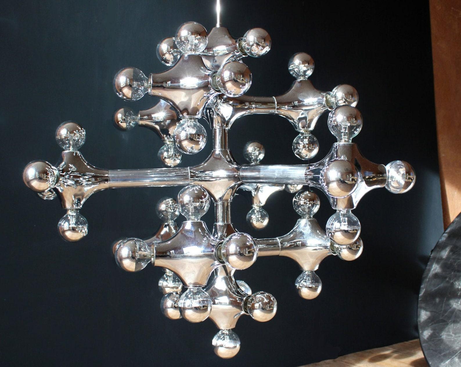 DIAMETER 3,6 FEET / HEIGHT OF THE BODY 3,3 FEET/ TOTAL HEIGHT 4,5 FEET

MONUMENTAL 43 LIGHTS (E27) GERMAN ORGANIC MOLECULES CHANDELIER MIRRORED 1960s 1970s

Exceptional architecture need special solutions for lighting! This extraordinary