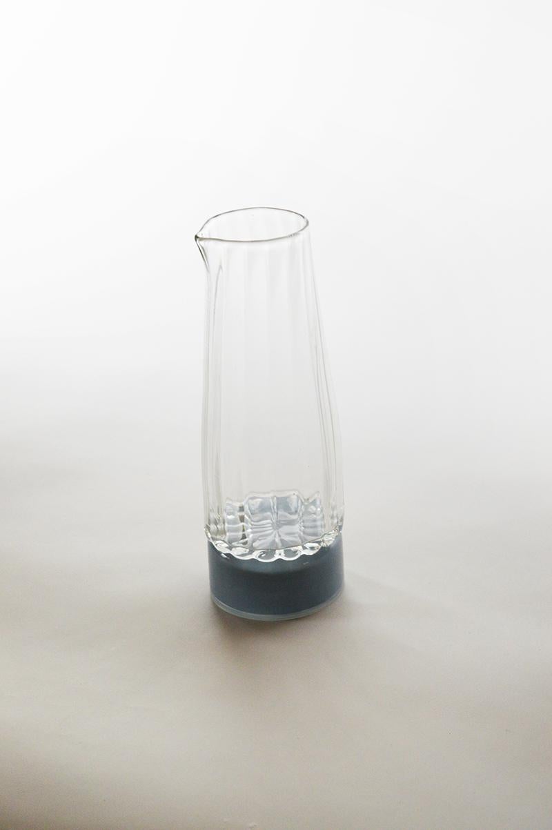 Unique glass carafe by Atelier George
One of a Kind
Dimensions: Ø 80 x H 22 cm 
Materials: Handblown glass

Variation of colours available. 

The Moire collection is the result of a work on optical and transparency effects. It is named after