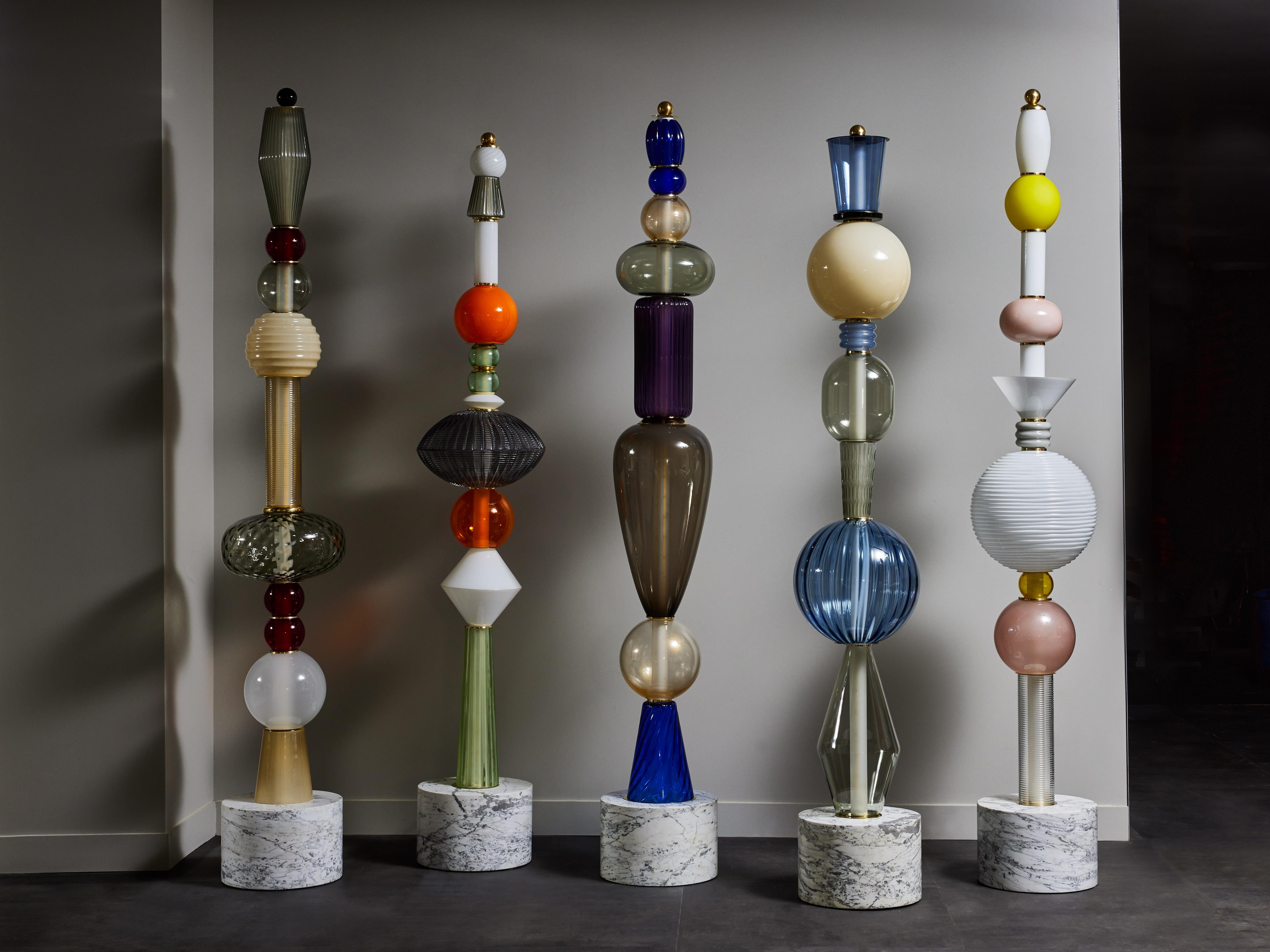 Built like totems, we used a Carrara marble base then stacked different Murano glass parts in various colors and shapes, alternating with some brass discreet elements.

Sold separately, price displayed for one floor lamp.
 