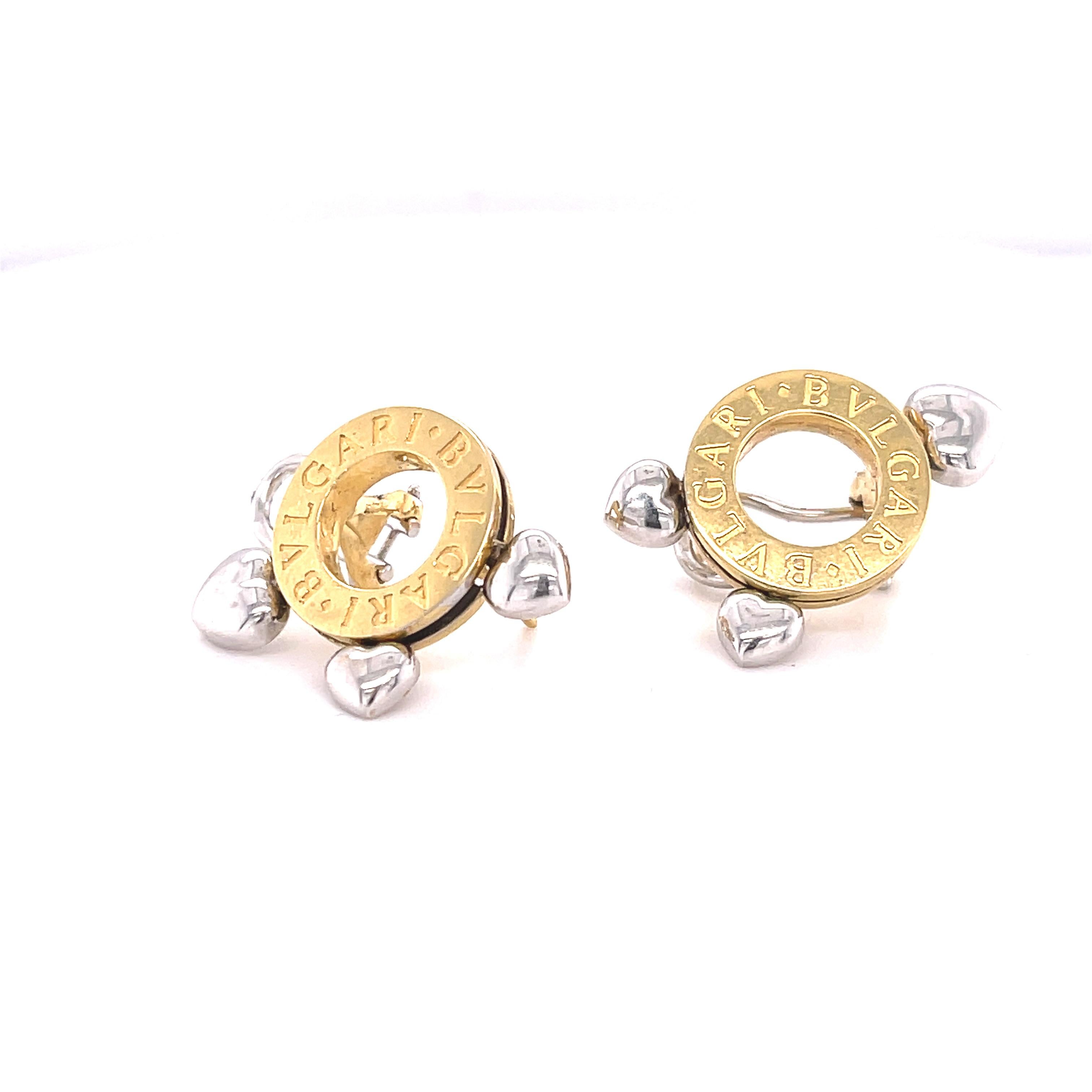 These is a beautiful set of earrings! Bvlgari is clearly displayed o the yellow gold circle of the main part of the earrings. Then three white gold hearts dangle at the bottom. The hearts can move around the whole earrings. 

• Signed Bulgari