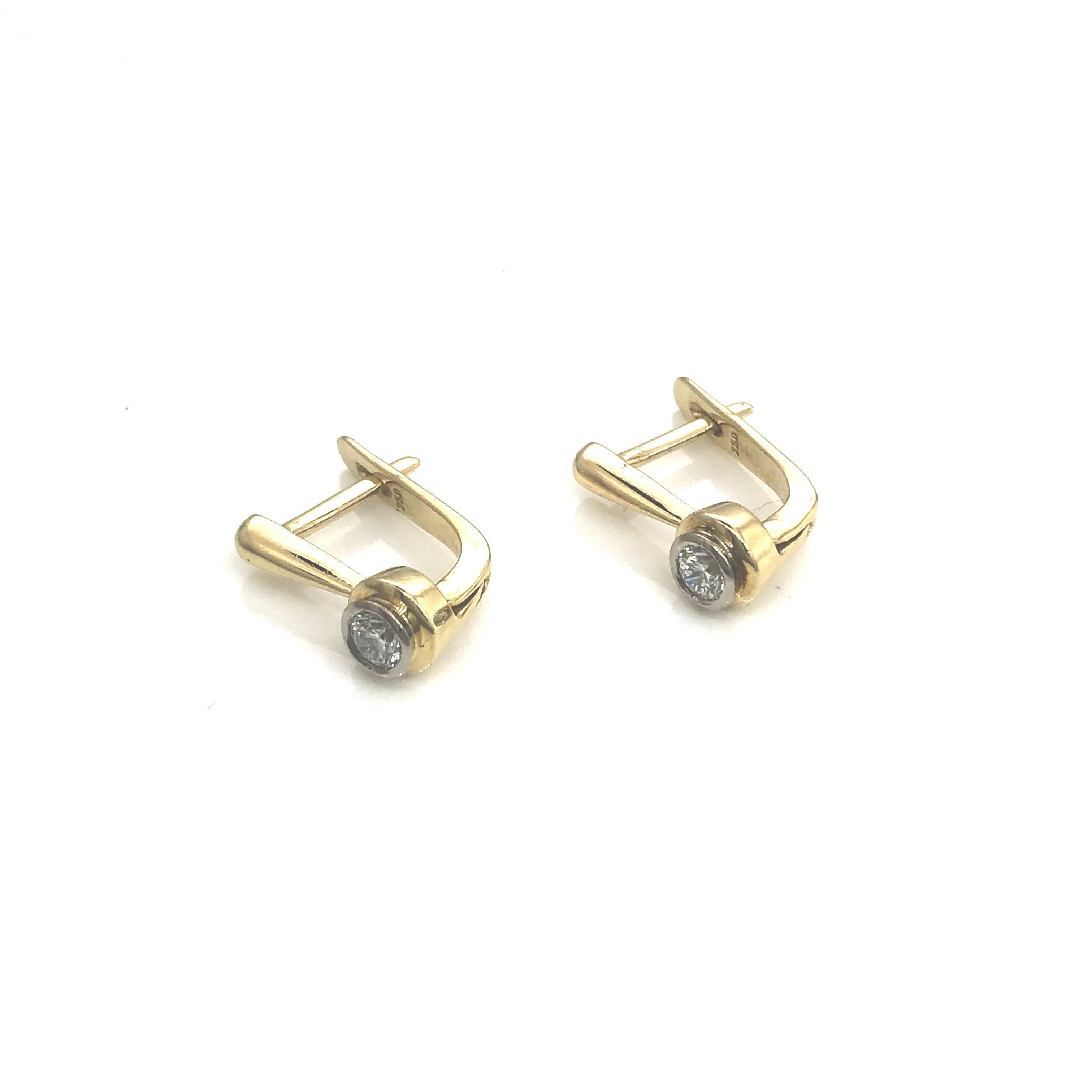 Elegant fully hand made 18 carat yellow gold earrings ,
each set with one round brilliant cut diamond totally weighing 0.30 carats
Classy rub-over setting and very safe Europen snap lock.
Weight of the earrings is 3.3 grams 
Lenth of the earrings is