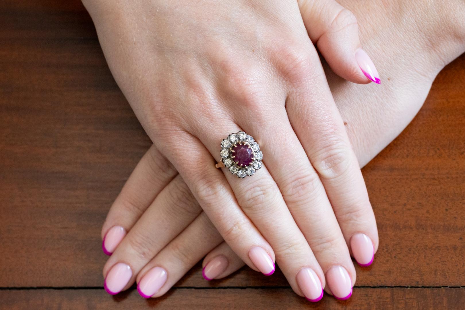 Impressive ring made of 18-karat yellow gold (0.750 fineness). Its front is decorated with an oval, faceted ruby ​​weighing approx. 1.87 ct. Natural ruby, opaque with a deep red color. Ruby surrounded by 12 brilliant-cut diamonds with a total weight