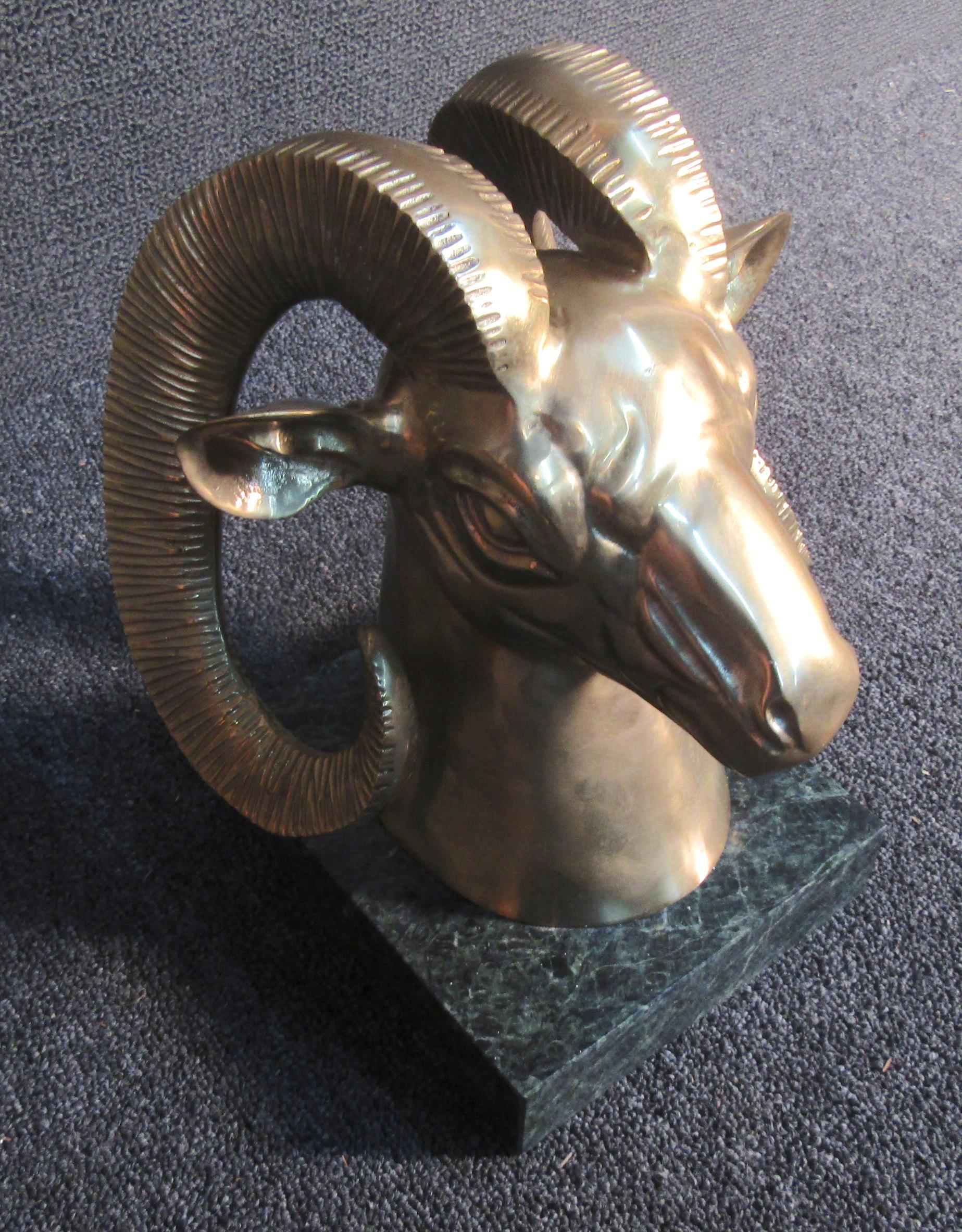 Stunning golden brass colored goats head sculpture mounted on a beautiful green marble base. This stunningly detailed sculpture would make a beautiful addition to any mantle or console table and is sure to draw lots of attention.

Please confirm